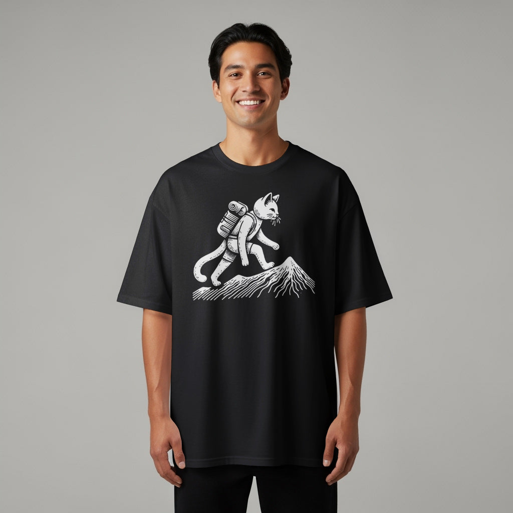 Black t-shirt with a white graphic of a cat hiking up a mountain.