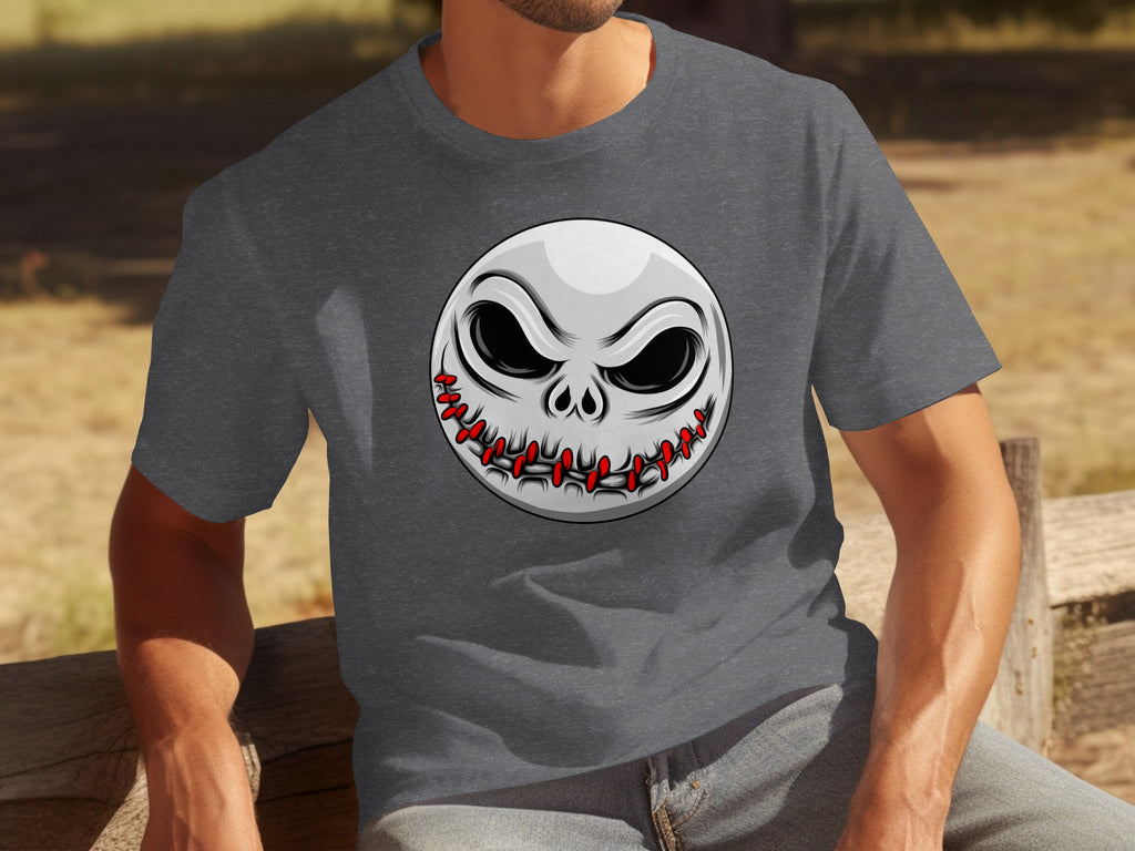 Dark grey t-shirt on a man with a stitched skull face graphic on the chest.