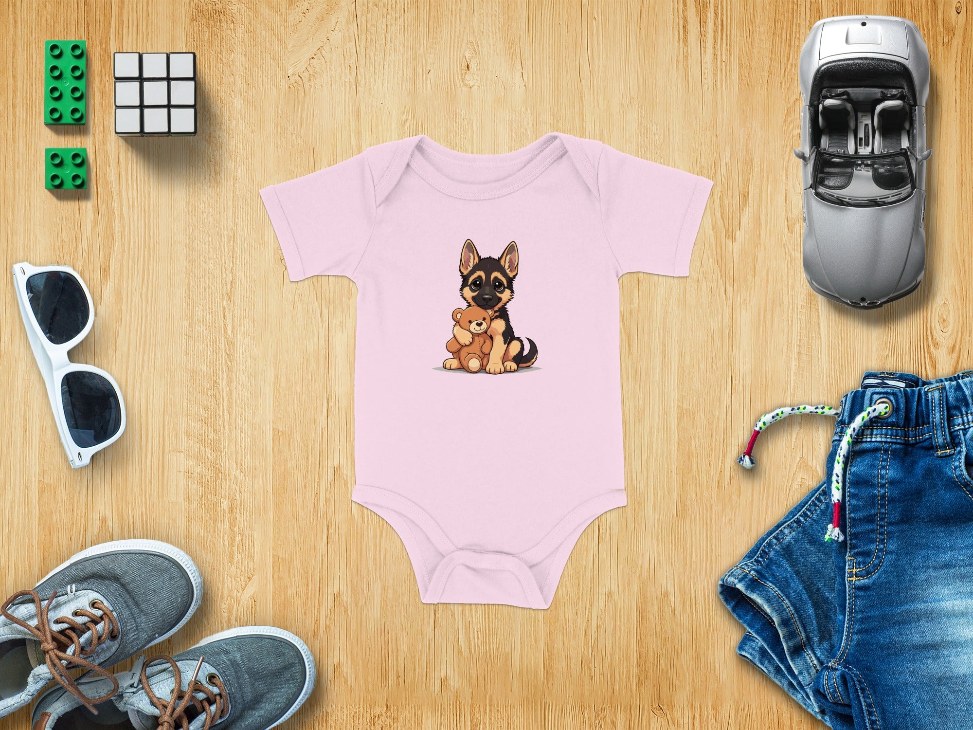 Pink baby onesie with a cartoon German Shepherd holding a teddy bear.