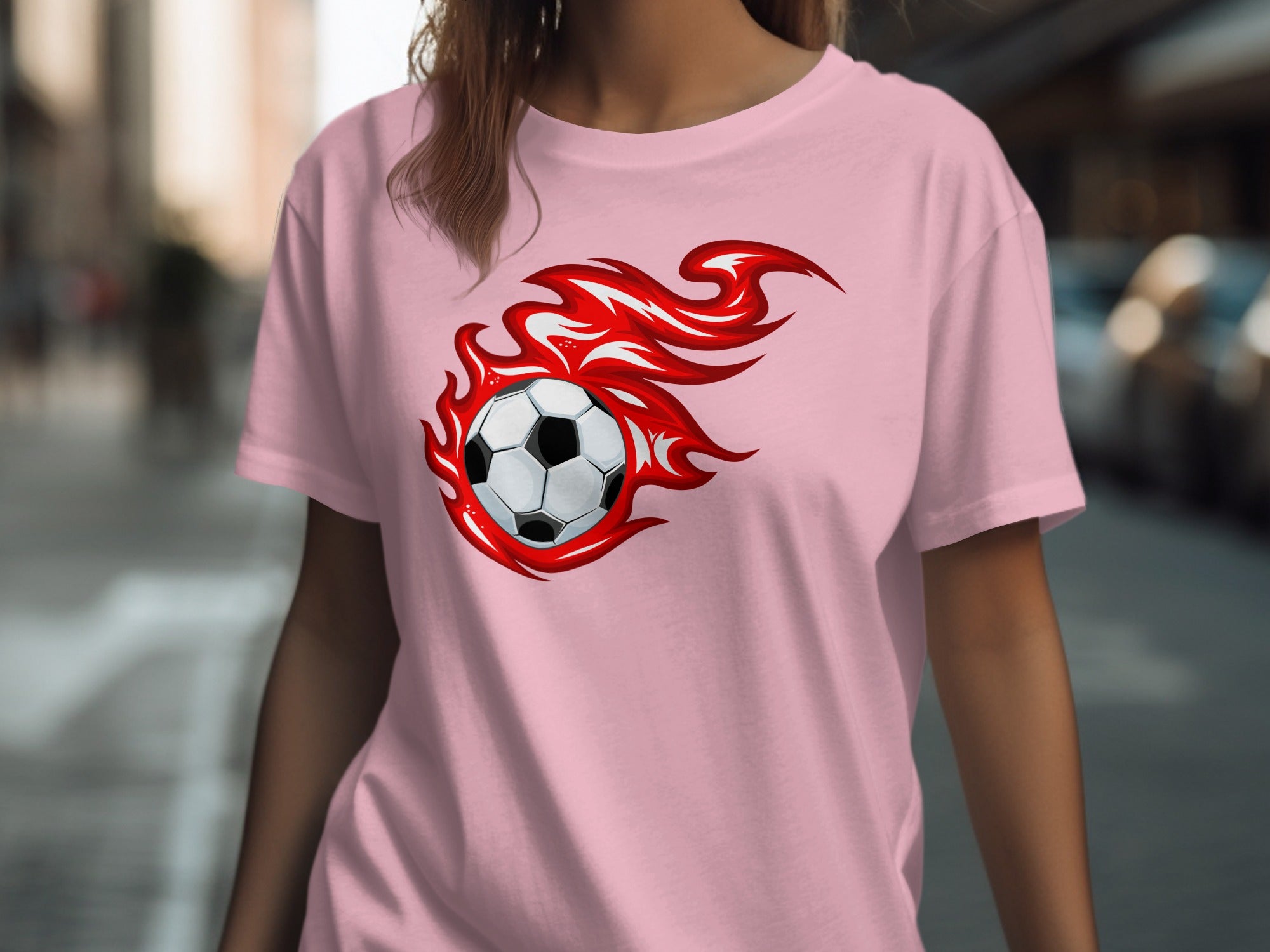Pink t-shirt with a soccer ball surrounded by red flames graphic.