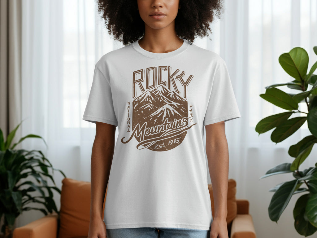 White t-shirt with brown graphic of Rocky Mountains, text "National Park Mountains Est. 1975".