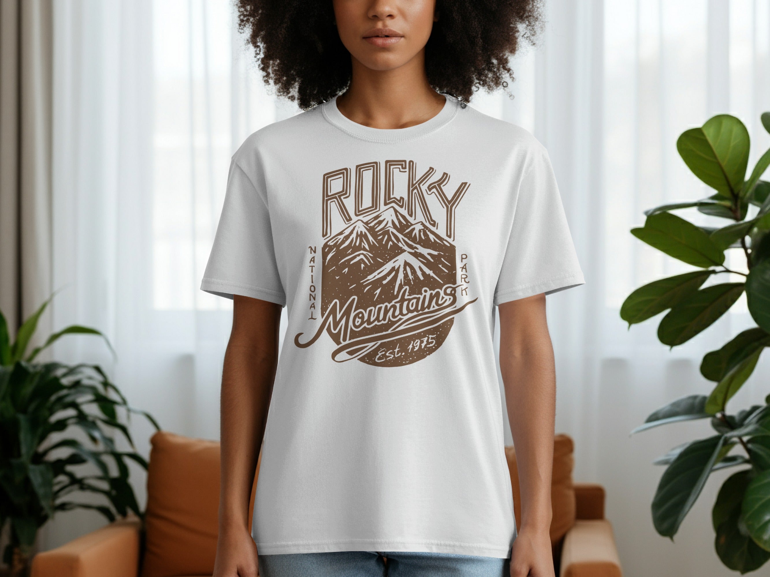 White t-shirt with brown graphic of Rocky Mountains, text "National Park Mountains Est. 1975".