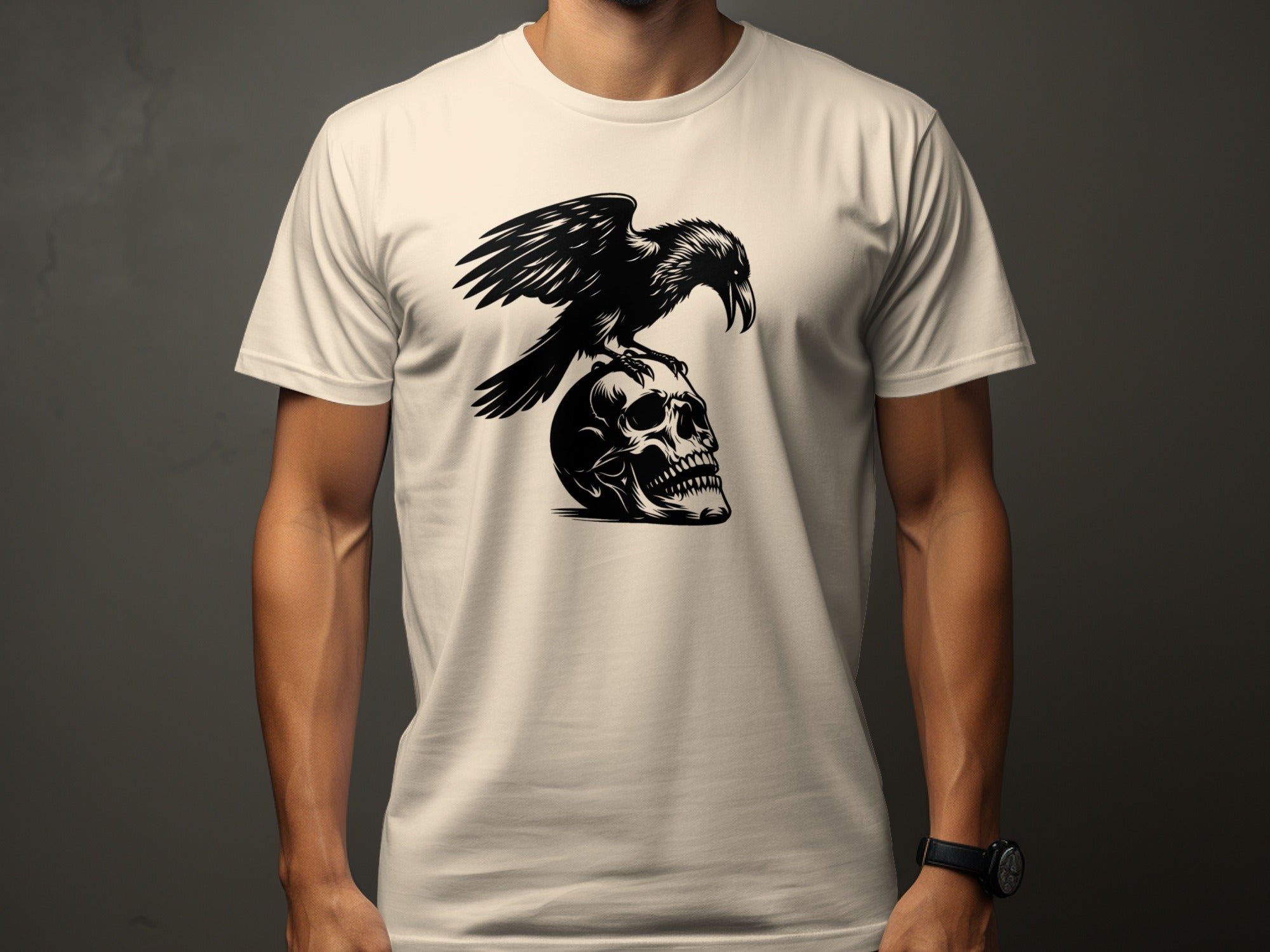 Black raven perched on a human skull graphic on a cream t-shirt.