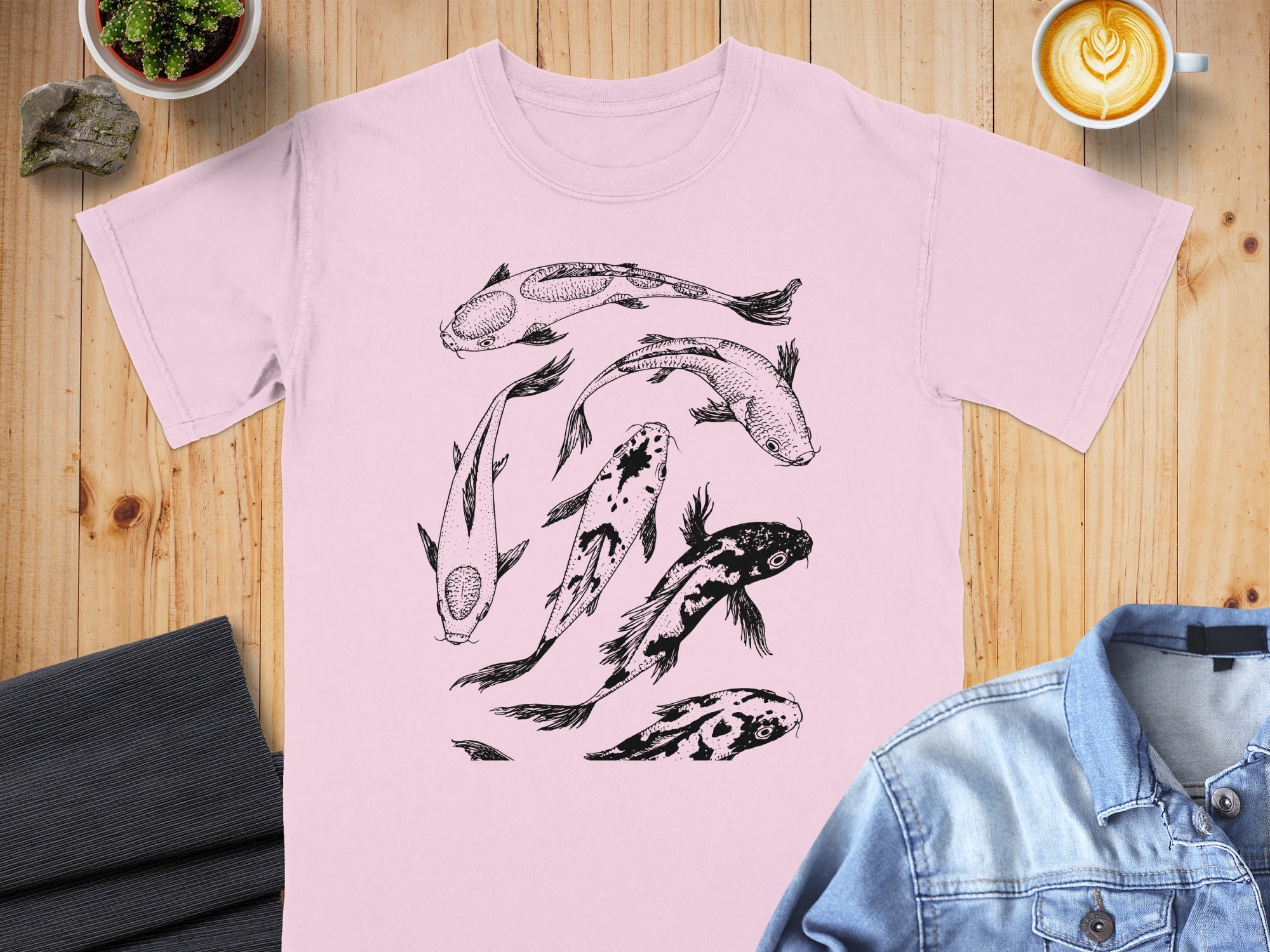 Pink t-shirt with a black sketch of koi fish swimming in a cluster.