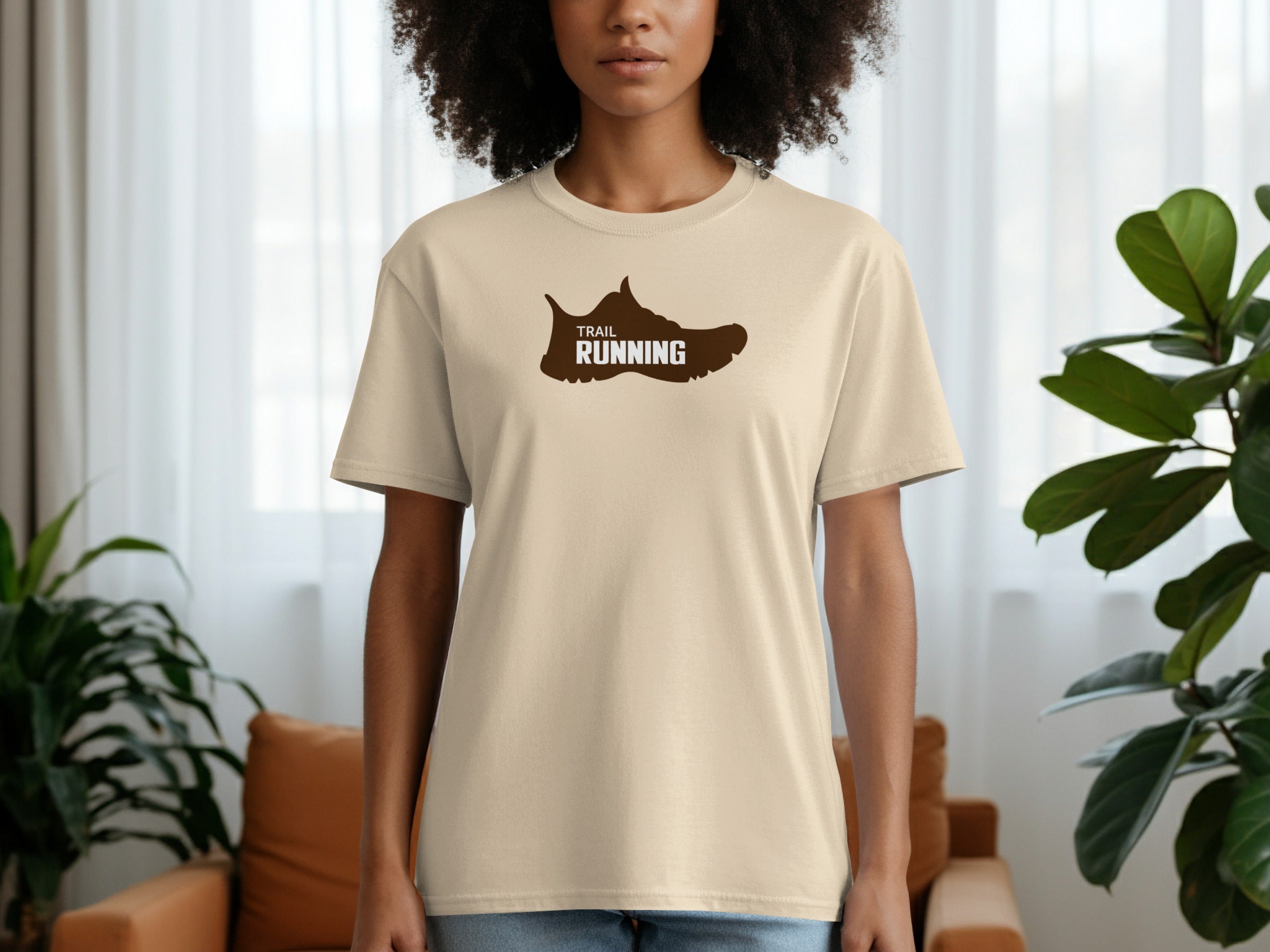 Beige t-shirt with brown trail running shoe graphic on chest.