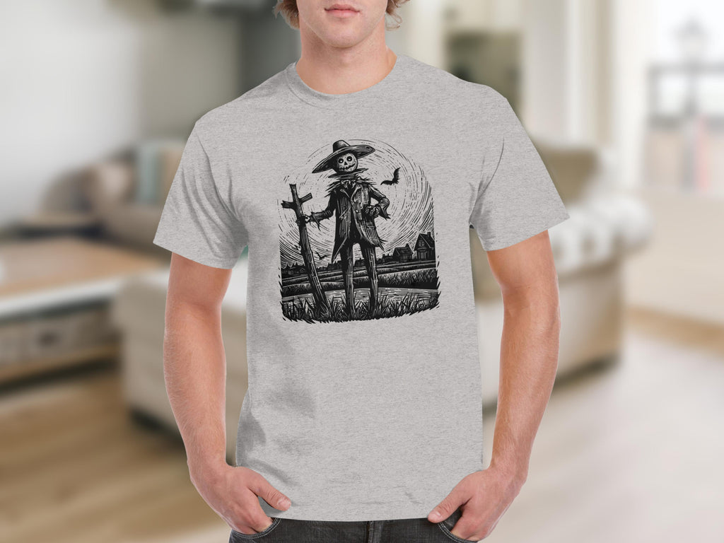 Black and white illustration of a scarecrow with a bat and two houses on a t-shirt.