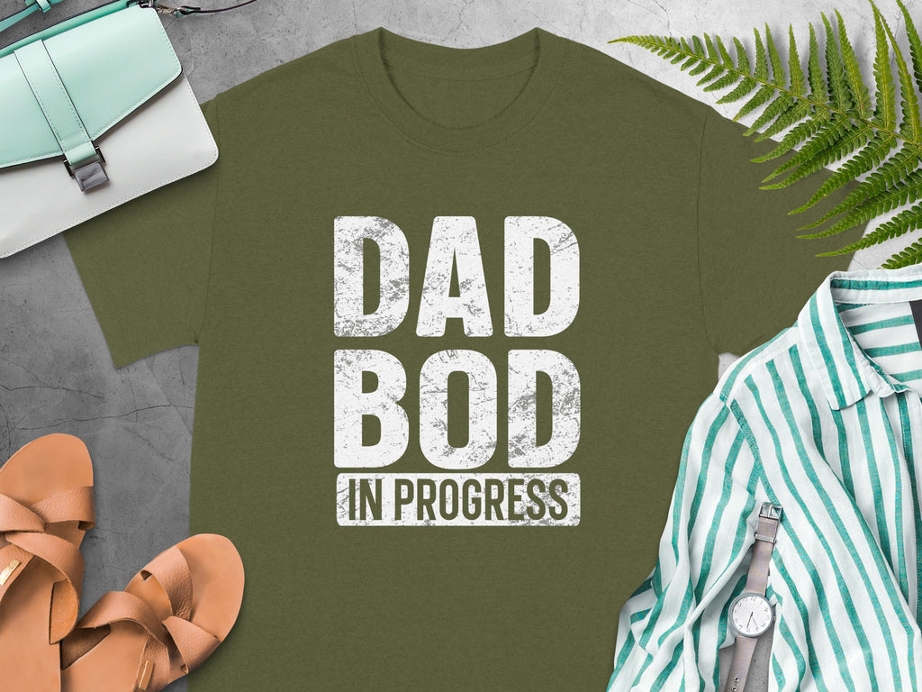 Olive green t-shirt with "DAD BOD IN PROGRESS" white text.