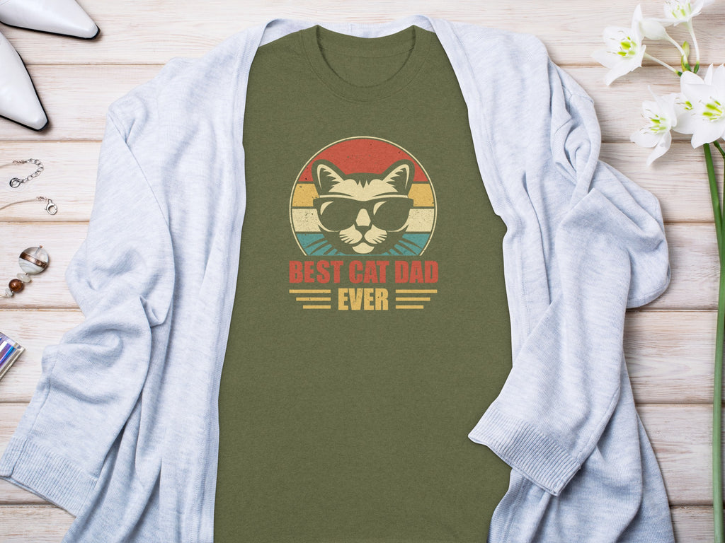 Olive t-shirt featuring a retro cat wearing sunglasses and the text "BEST CAT DAD EVER".