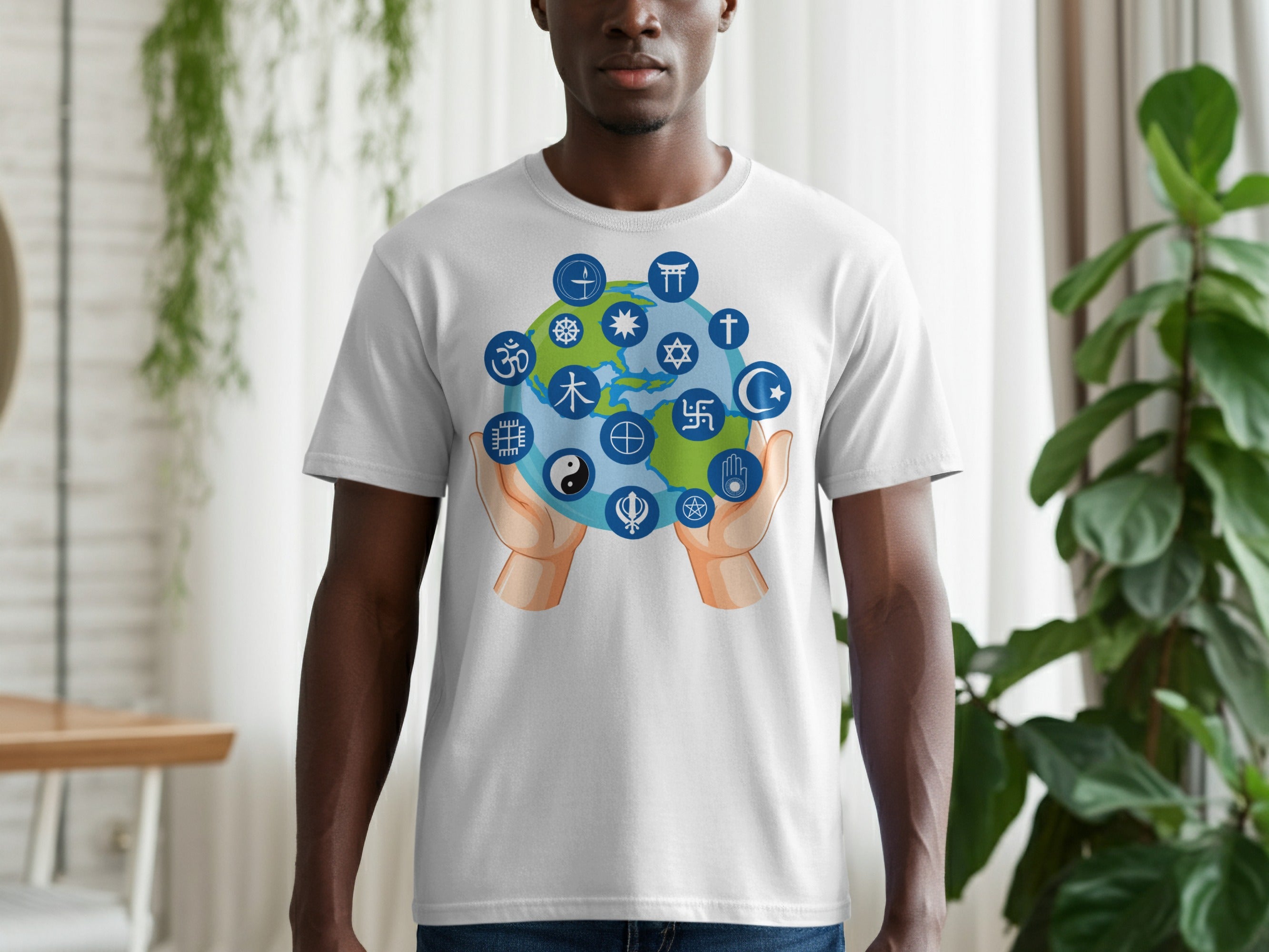 White t-shirt with a graphic of hands holding an earth with various religious symbols.