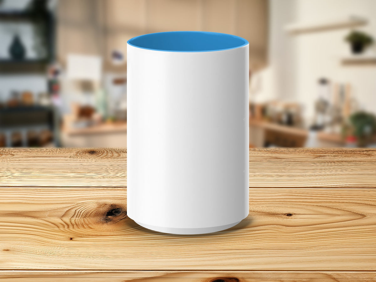 White cylinder mug with blue interior on a wooden table.