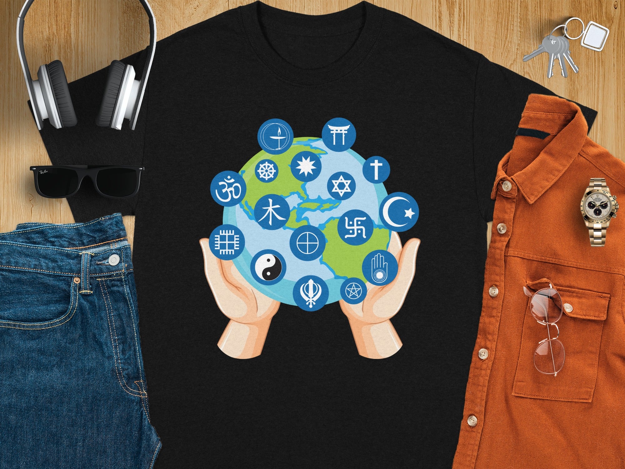 Black t-shirt with hands holding a globe featuring various religious and cultural symbols.