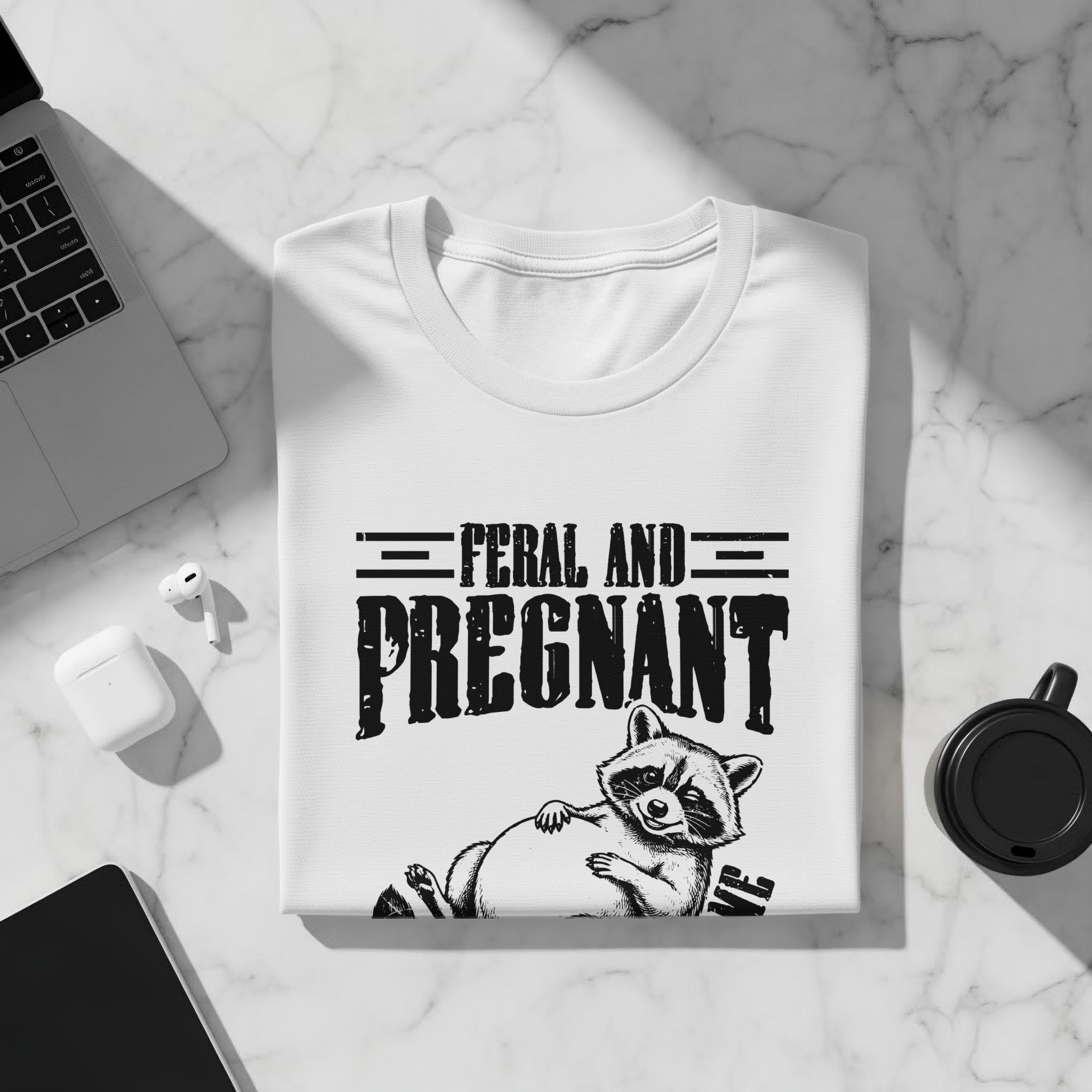 White t-shirt with feral and pregnant text and illustrated raccoon
