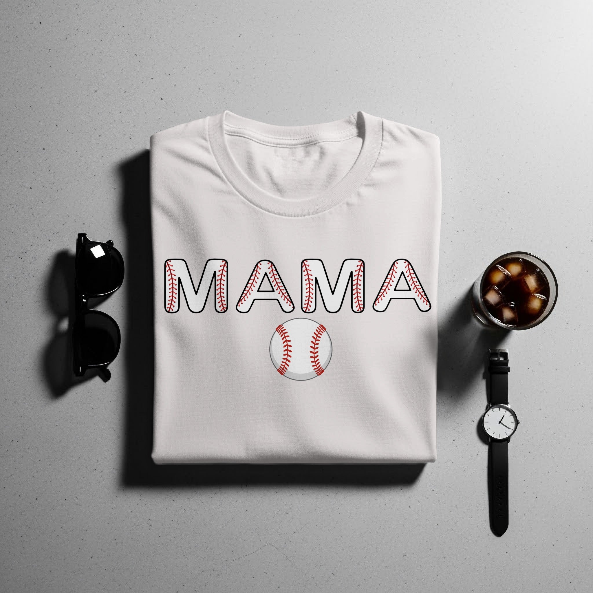 White t-shirt with "MAMA" text and baseball design and baseball below.