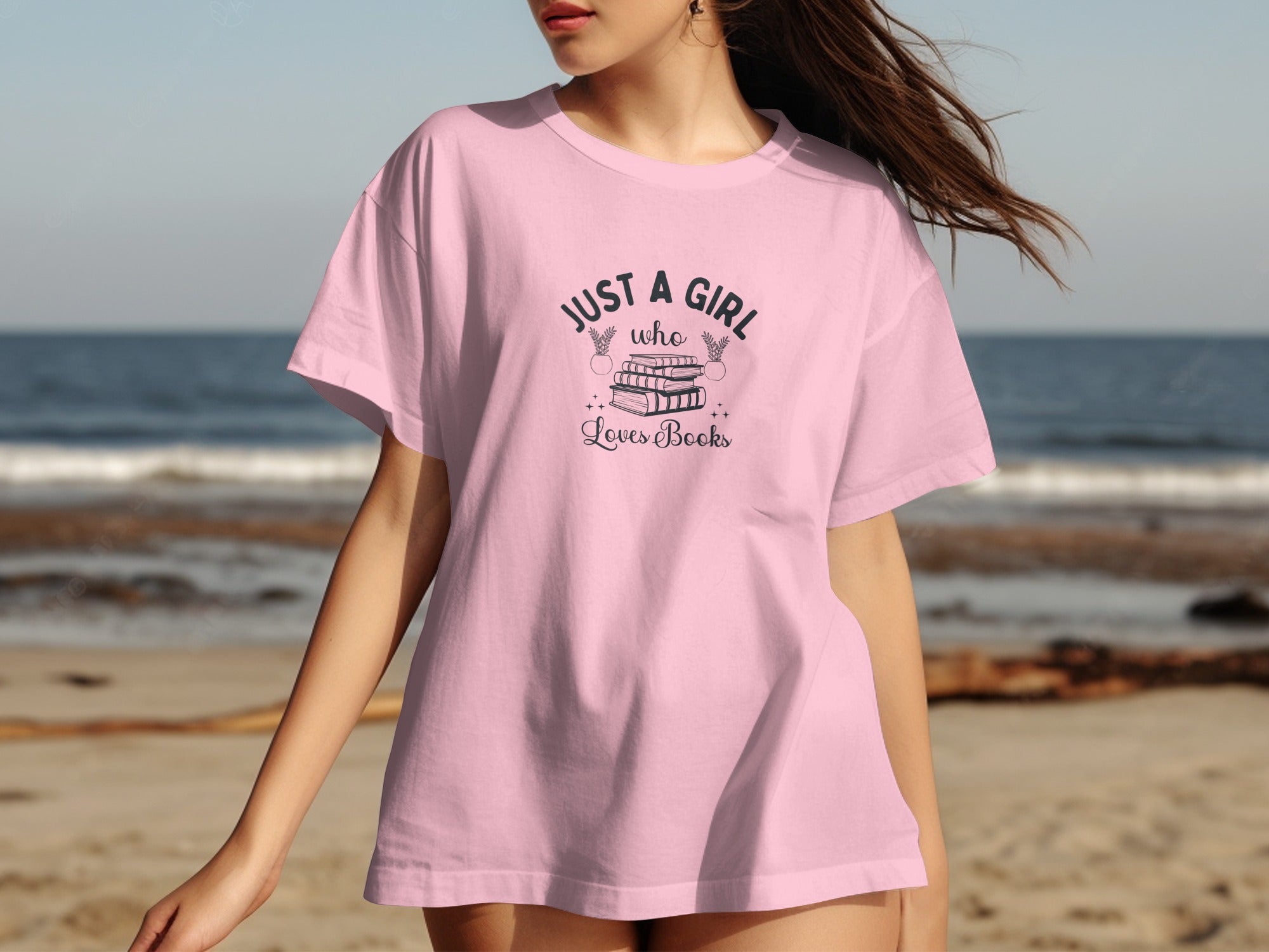 Pink t-shirt with "JUST A GIRL who Loves Books" text and stack of books graphic.