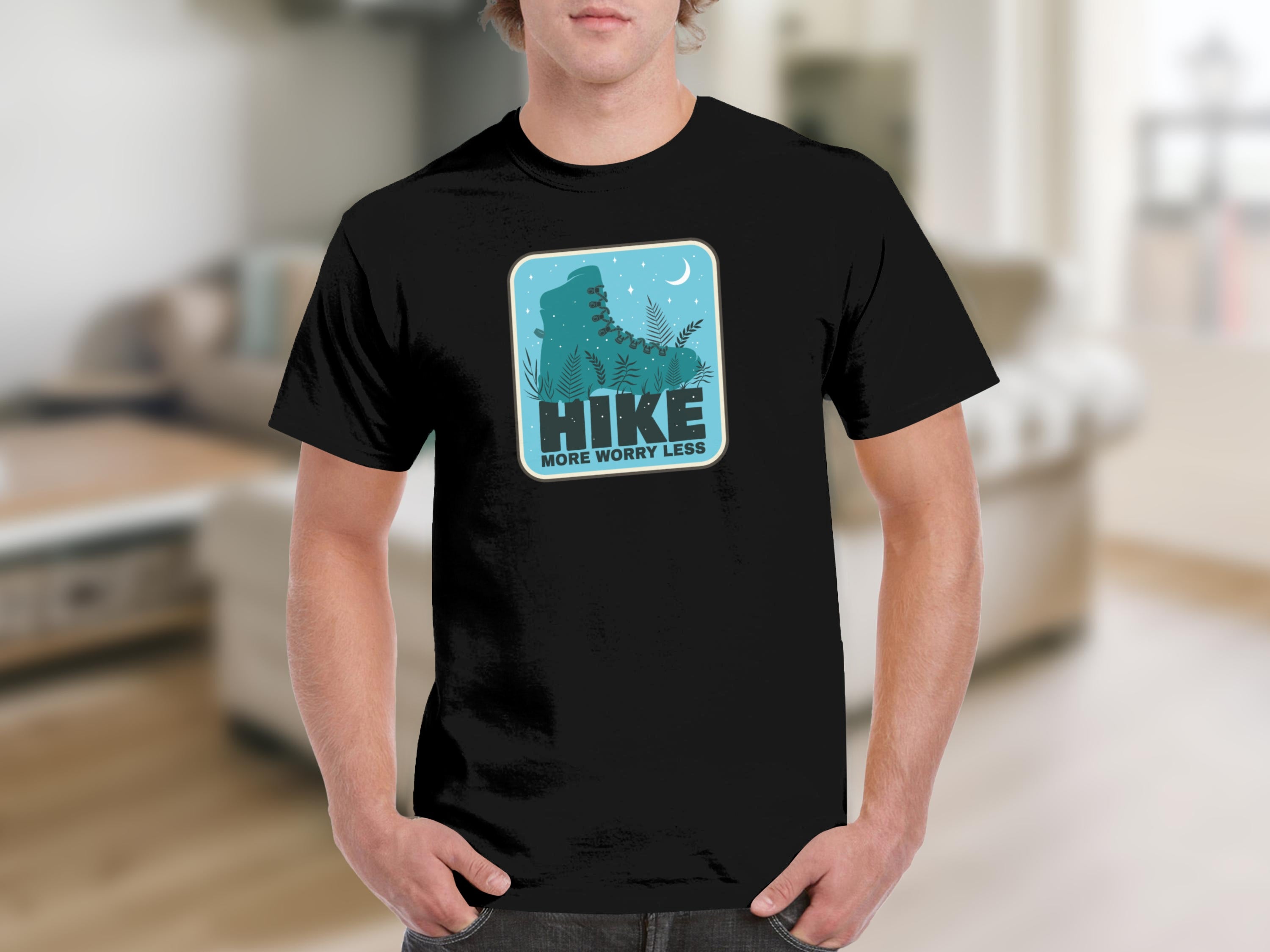 Black t-shirt with a graphic of a teal hiking boot and plants, with the words "HIKE MORE WORRY LESS."