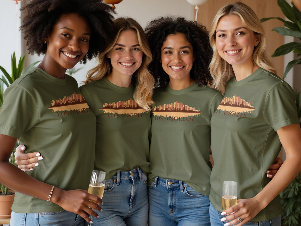 Four women wear olive green t-shirts with a Los Angeles skyline graphic.
