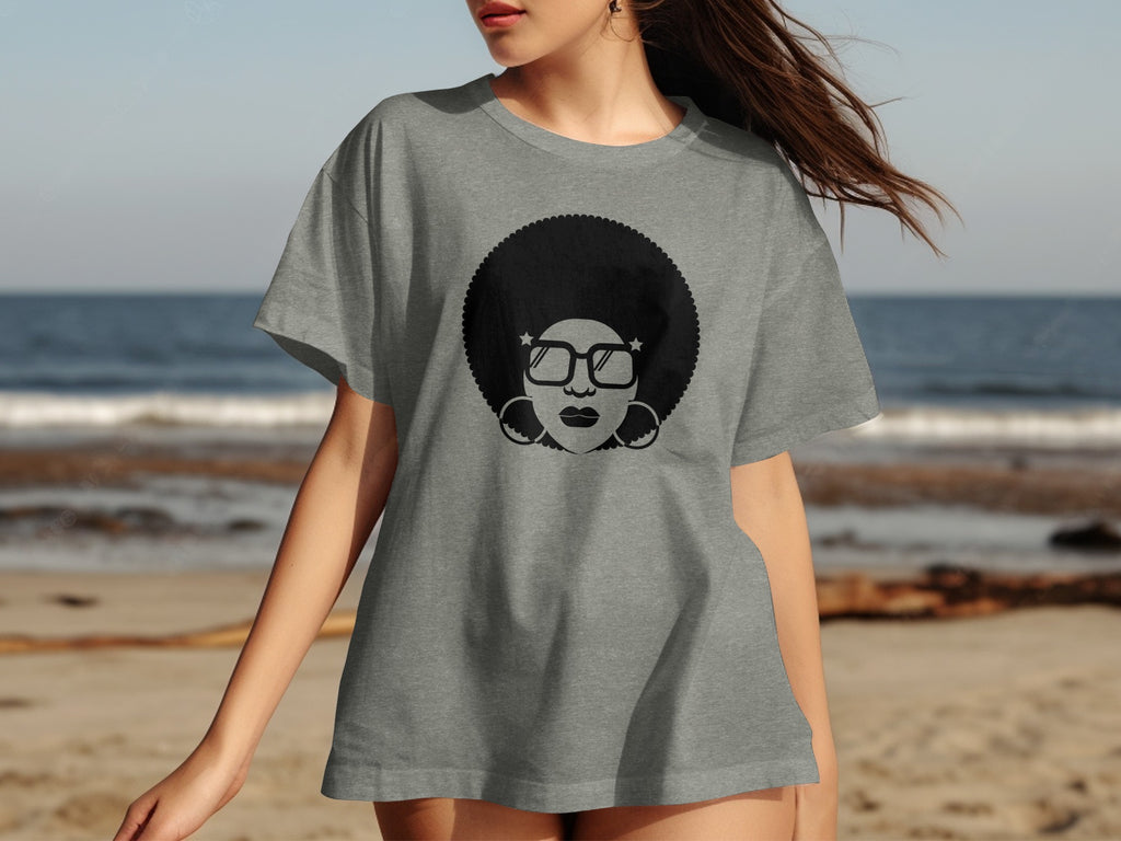 Gray t-shirt with black graphic of a woman with an afro and glasses.