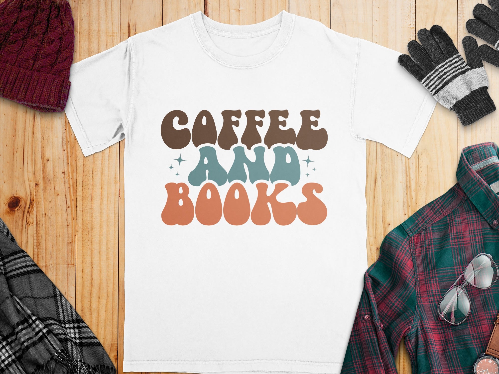 White t-shirt with brown, teal, and orange "Coffee And Books" text.