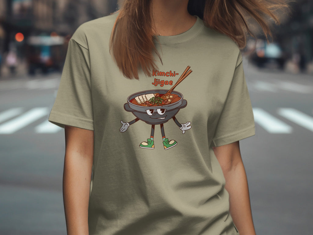 A cartoon Kimchi Jjigae dish with legs and arms on a tan t-shirt.