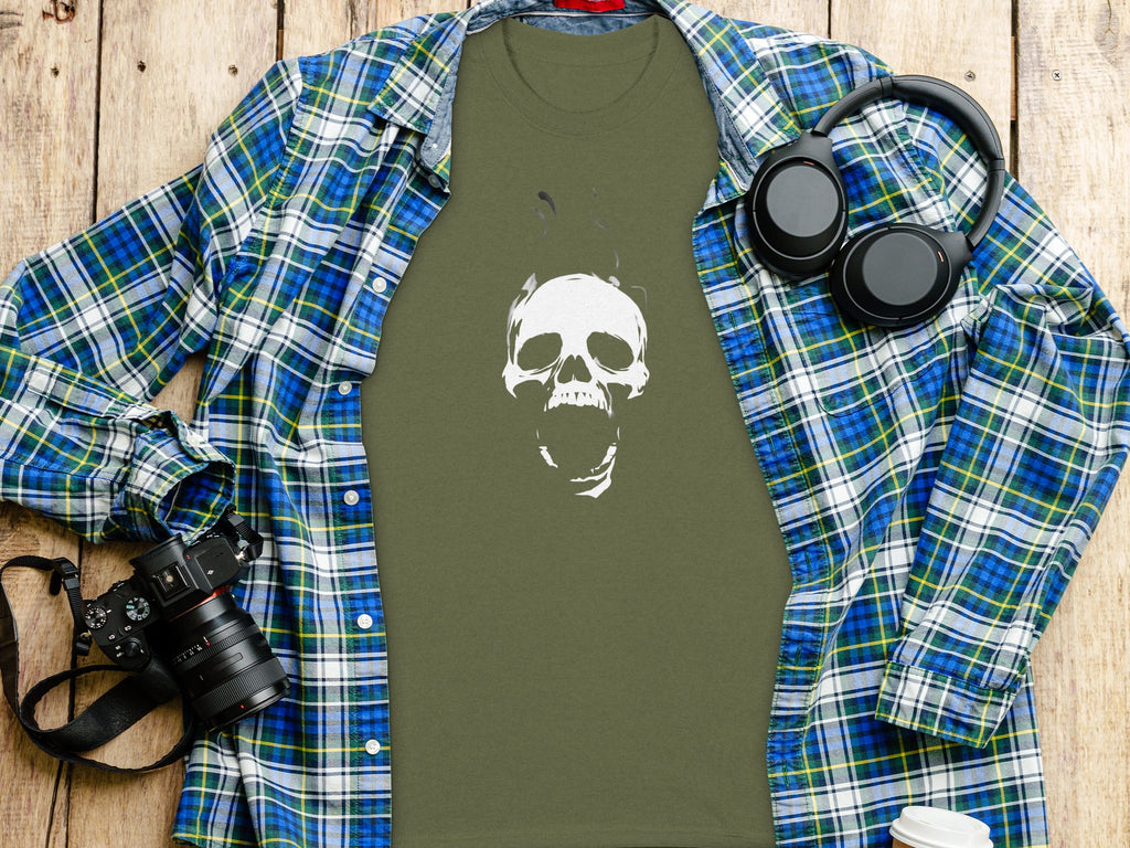 Olive t-shirt with white smoking skull graphic, blue plaid shirt, headphones, and camera.