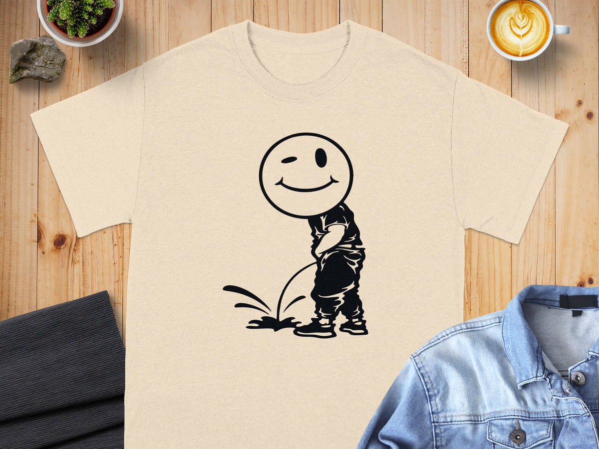T-shirt with black graphic of a winking smiley face figure urinating.