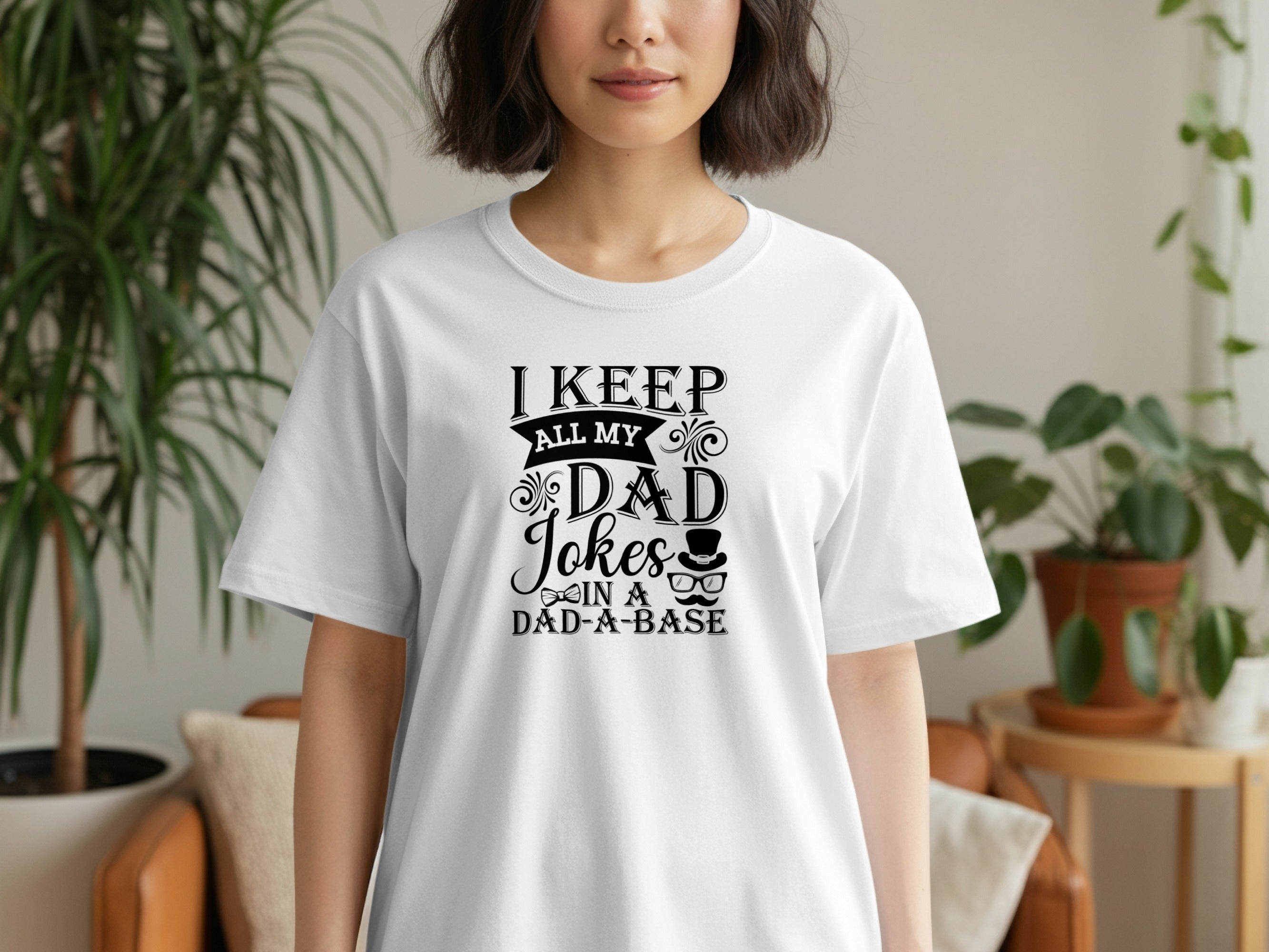 White t-shirt with black text: "I keep all my dad jokes in a dad-a-base."
