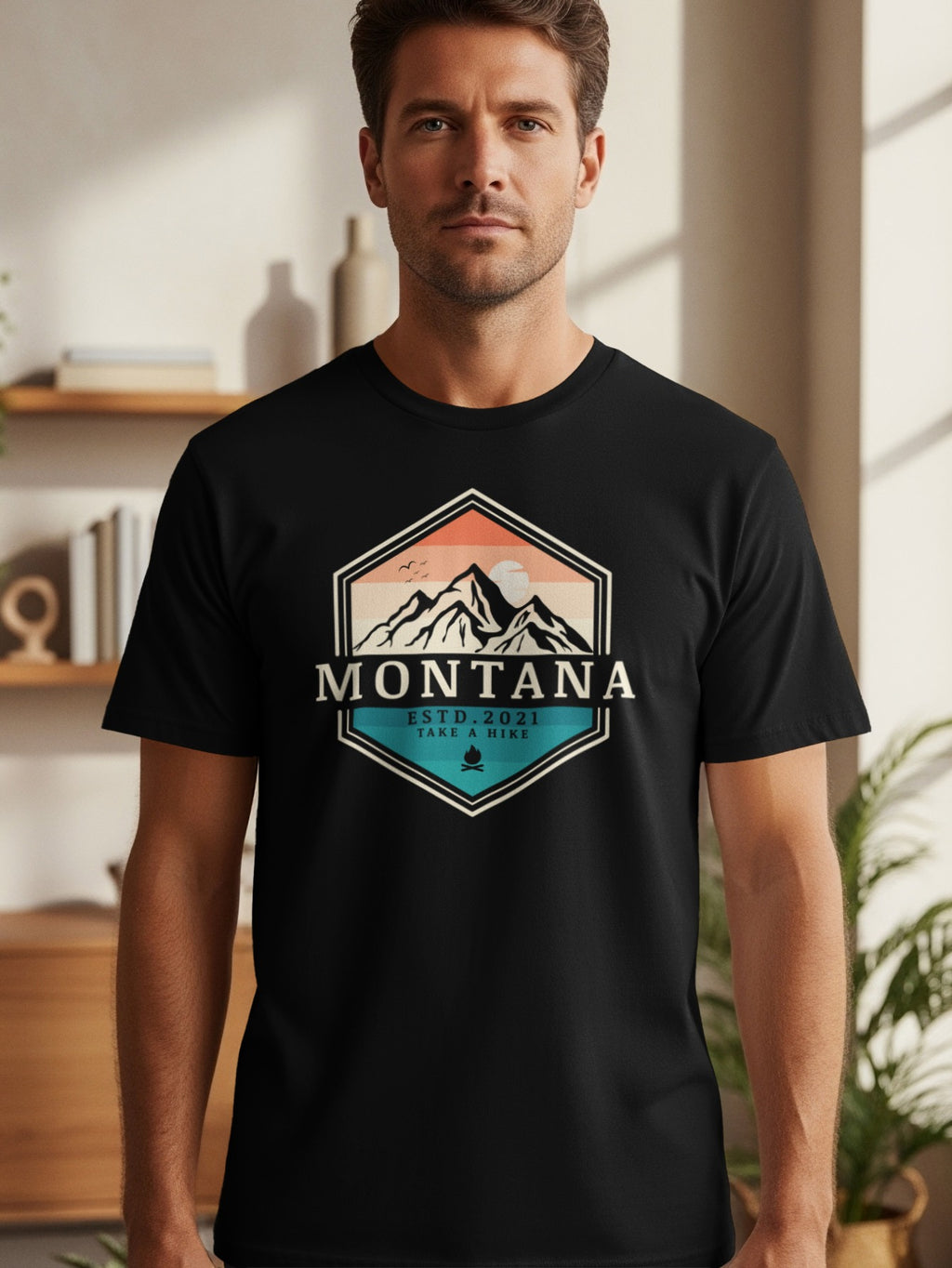 Black t-shirt with hexagon design featuring mountains, text "MONTANA ESTD. 2021 TAKE A HIKE".