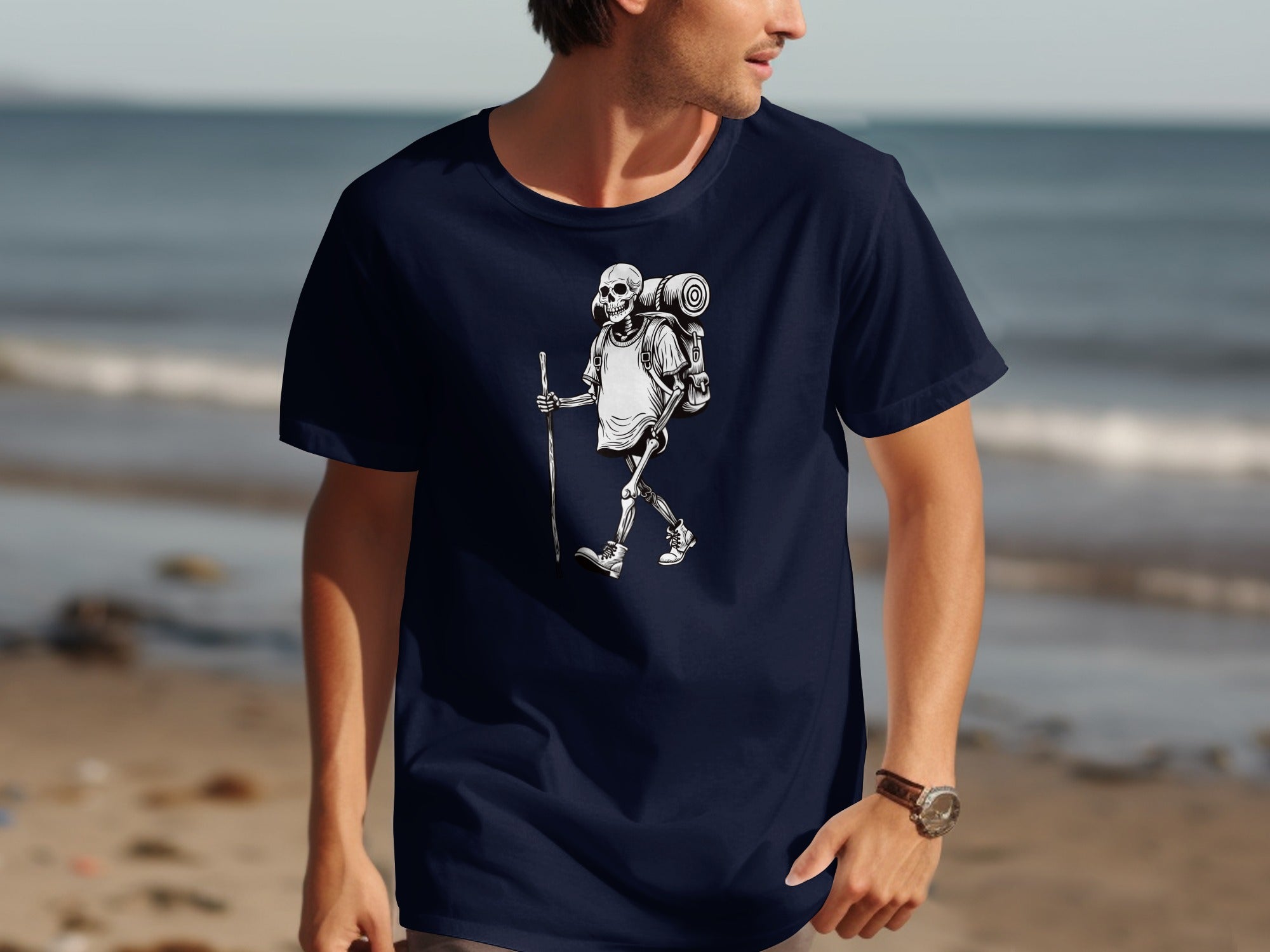Skeleton hiker with a backpack and walking stick graphic on a navy t-shirt.
