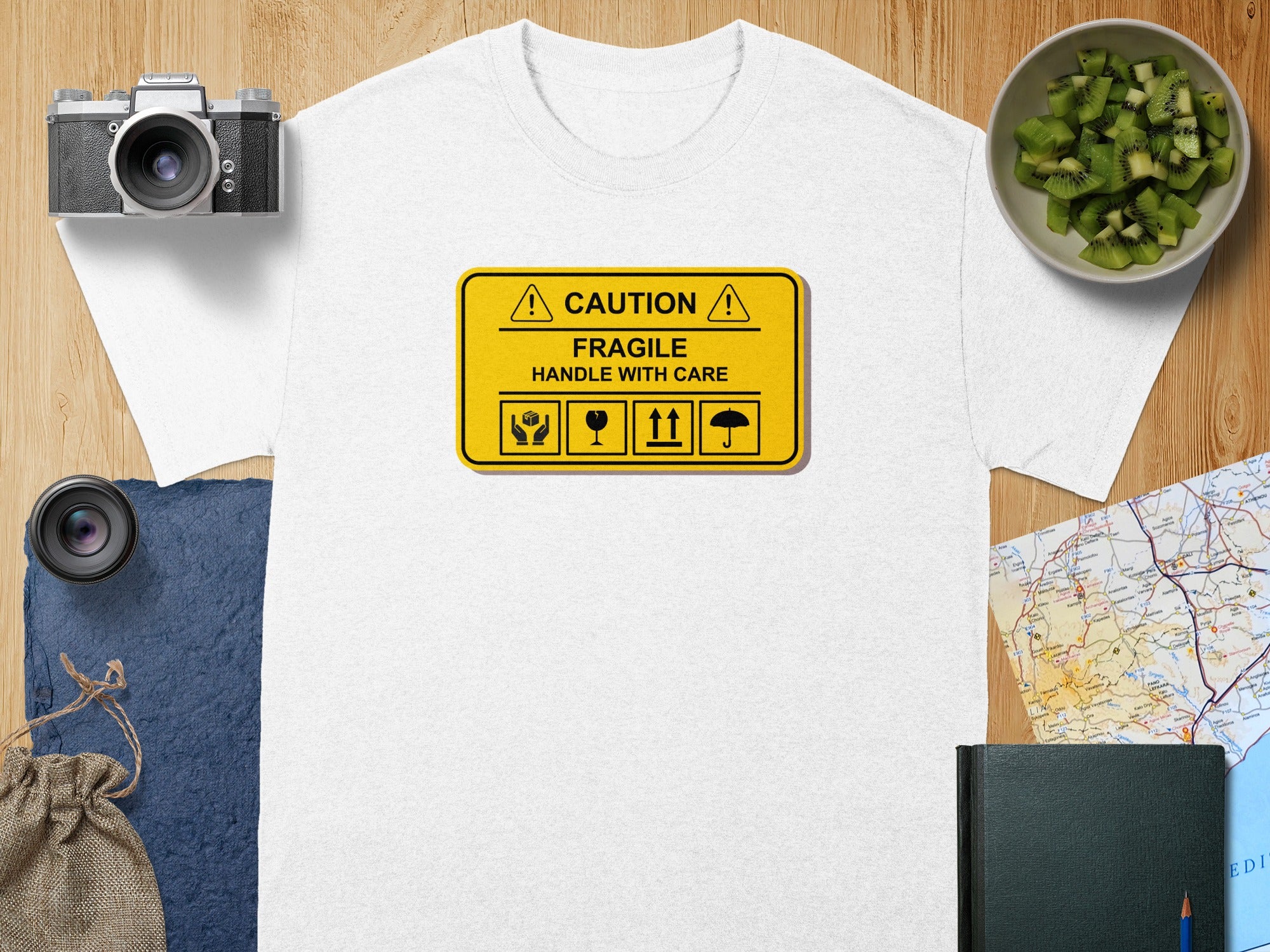 White t-shirt with a yellow "Caution Fragile Handle With Care" sign design.