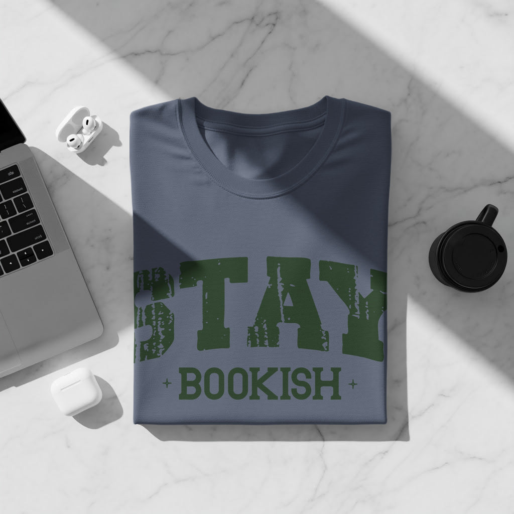 Blue t-shirt with green text "STAY BOOKISH" and a laptop.