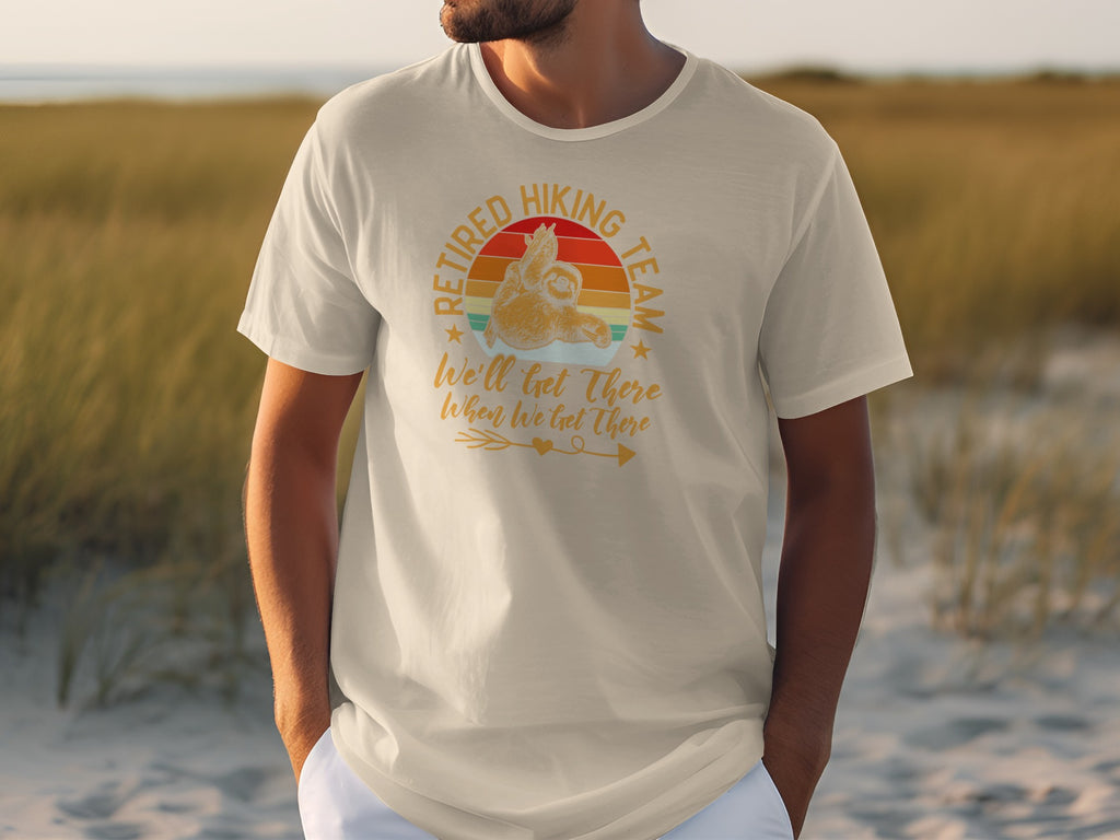 T-shirt graphic: "Retired Hiking Team" with sloth and sunset, says "We'll get there When We Get There".
