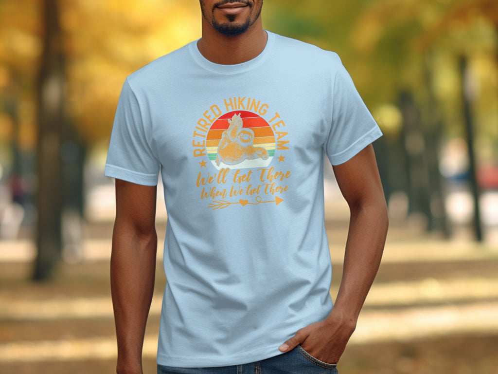 Light blue t-shirt with "Retired Hiking Team" text and sloth graphic.