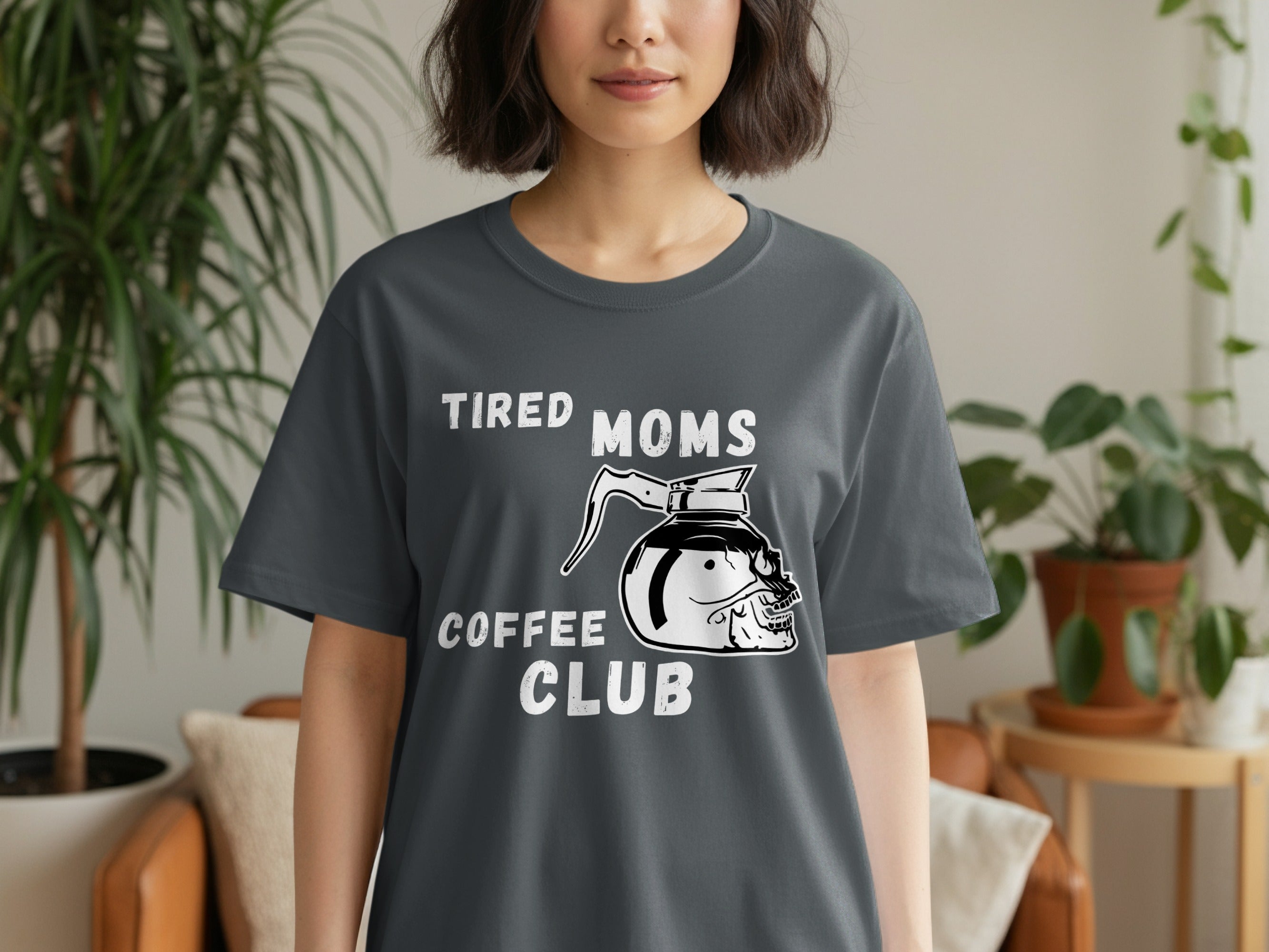 Dark gray t-shirt with text "TIRED MOMS COFFEE CLUB" and a skull coffee pot graphic.