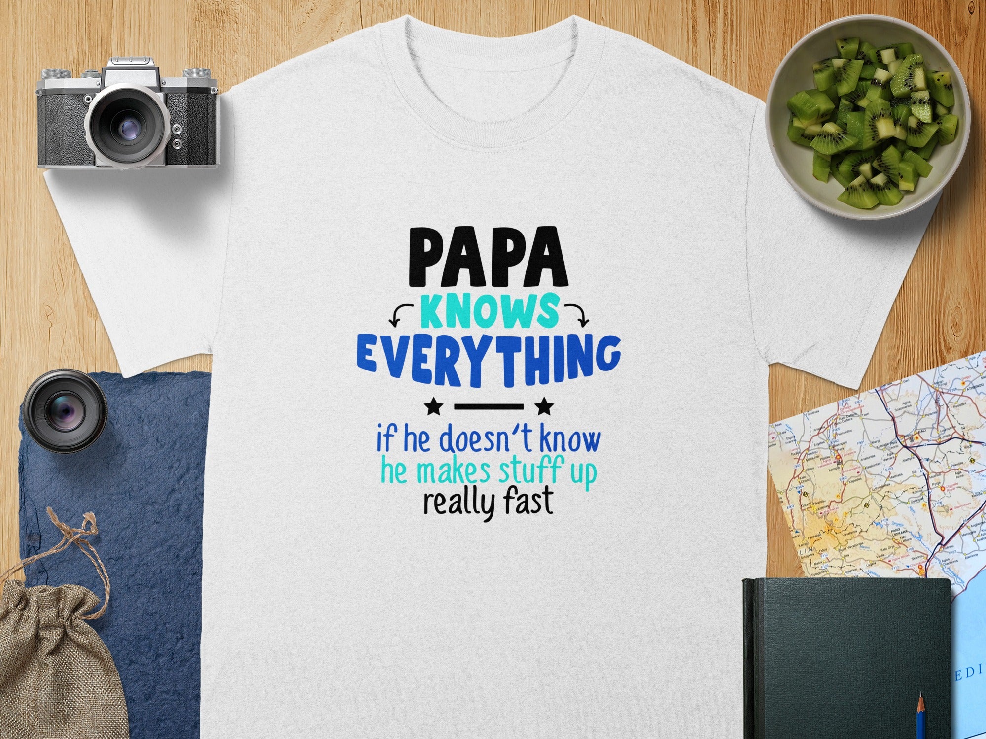 White t-shirt with "PAPA KNOWS EVERYTHING if he doesn't know he makes stuff up really fast" text.