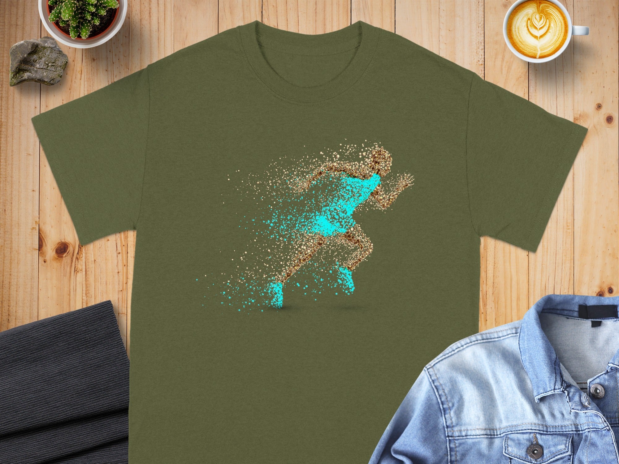 Olive green t-shirt with a dynamic runner graphic made of exploding particles.