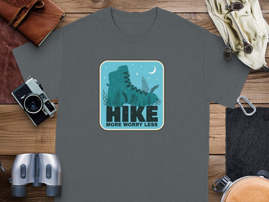 Gray t-shirt with a circular graphic of a hiking boot, ferns, moon, and stars.