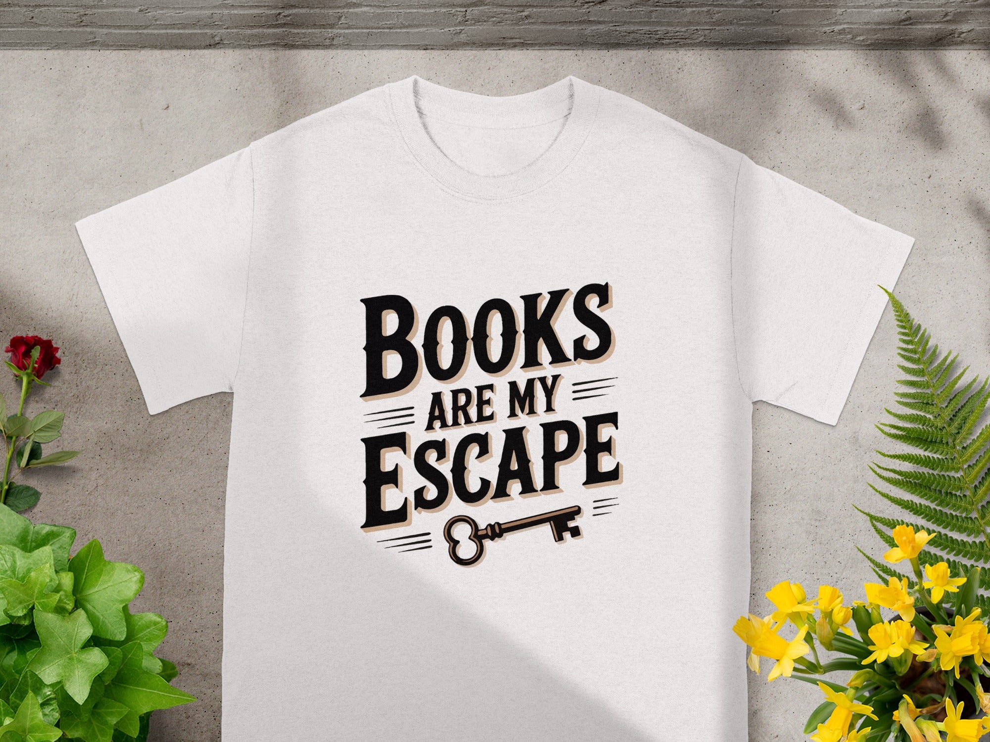 White t-shirt with "Books Are My Escape" text and an ornate key.