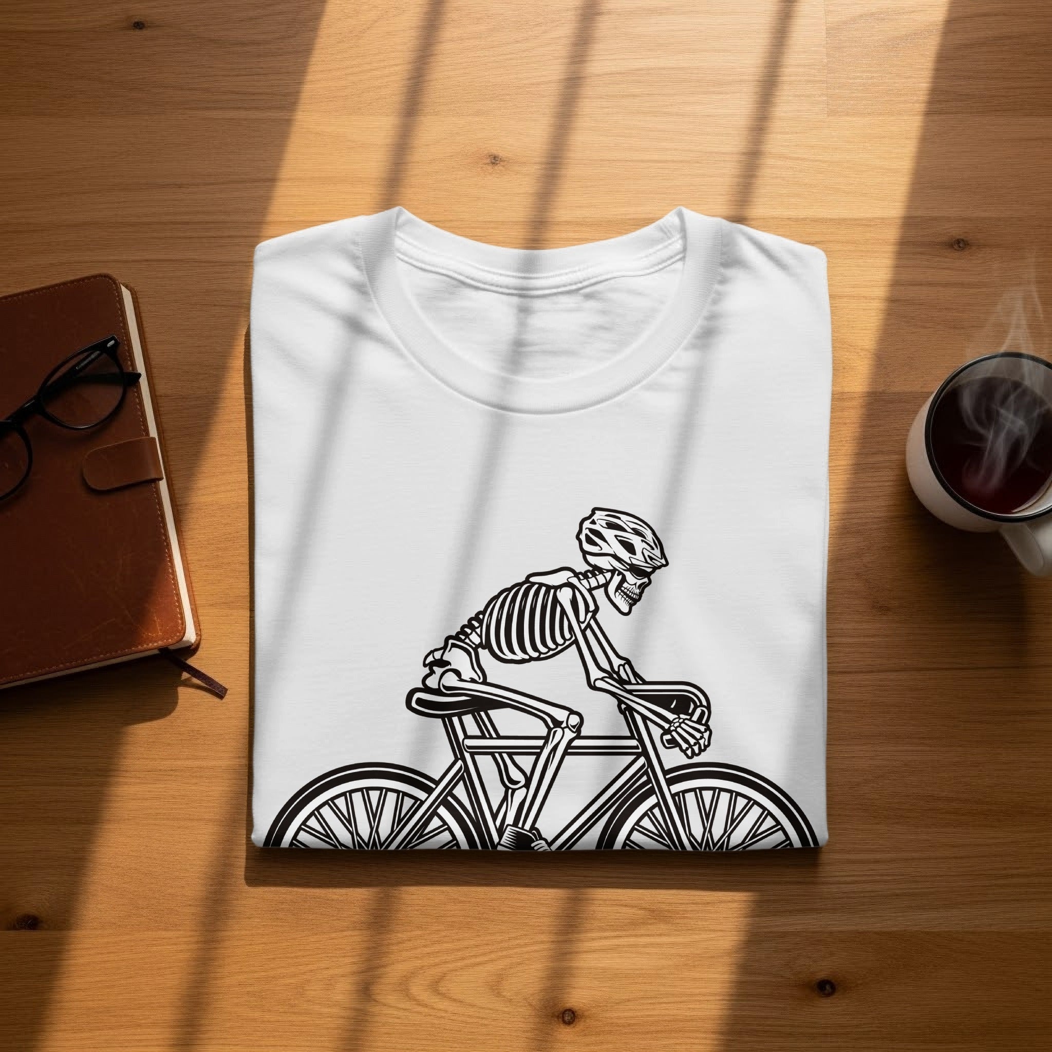 White t-shirt with a black graphic of a skeleton riding a bicycle.