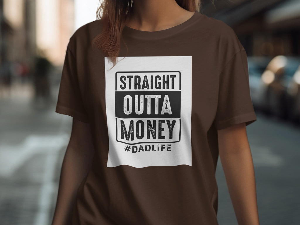 Brown t-shirt with white graphic text reading "STRAIGHT OUTTA MONEY #DADLIFE".