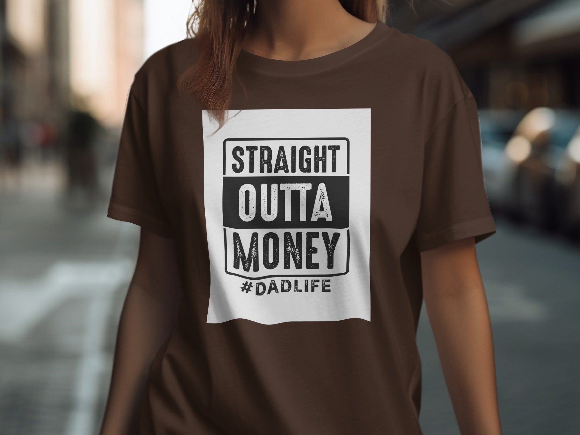 Brown t-shirt with white graphic text reading "STRAIGHT OUTTA MONEY #DADLIFE".