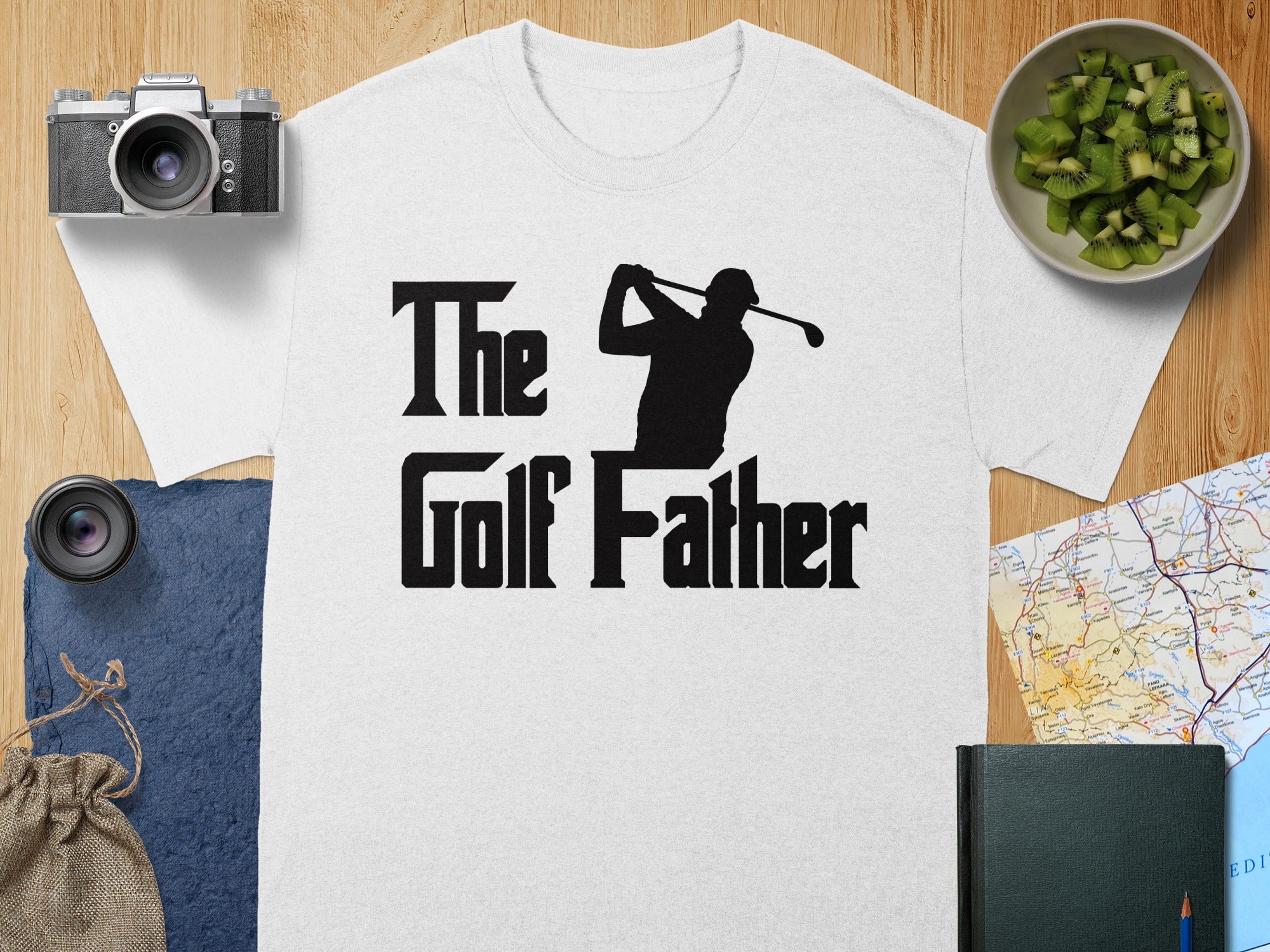 White t-shirt with black text and golfer silhouette, "The Golf Father".