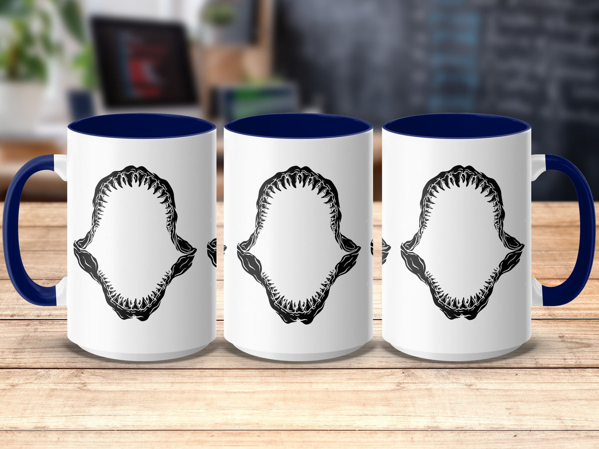 Three white mugs with blue handles and rims, featuring a black shark jaw graphic.