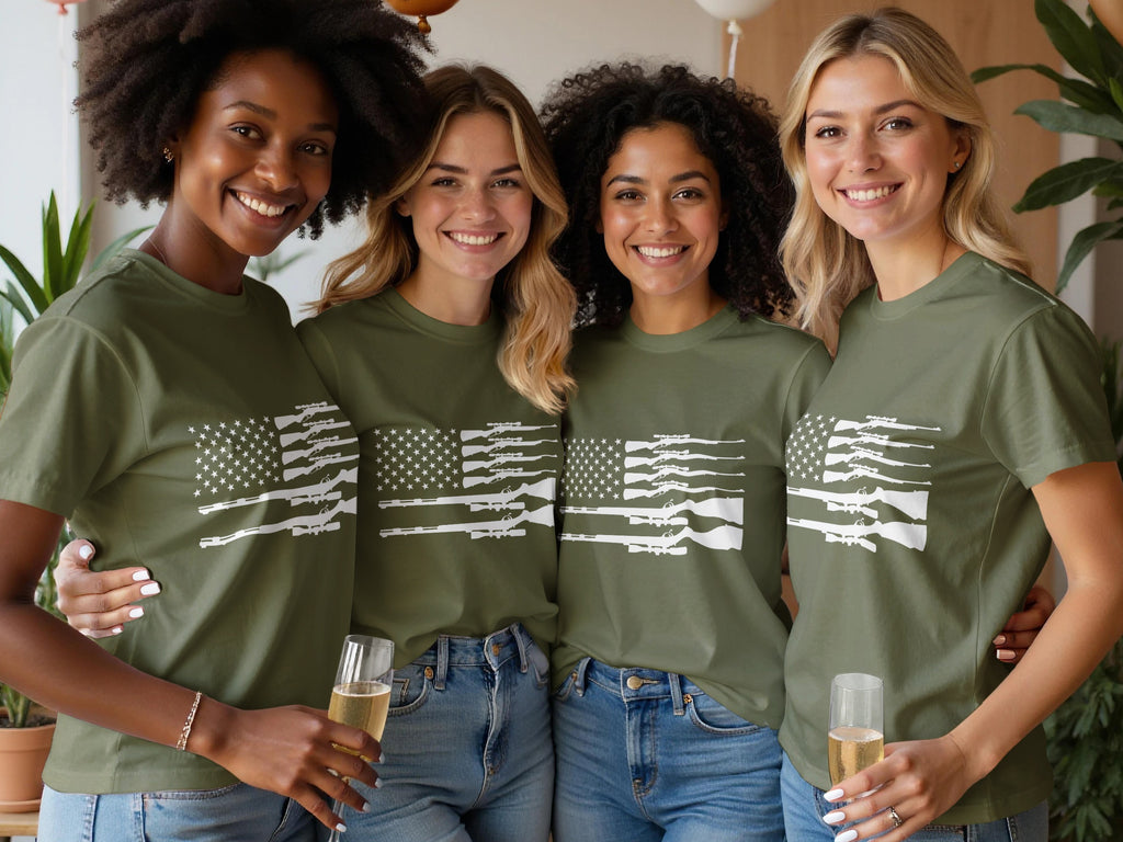 Four women in olive green shirts with white rifle flag design, holding champagne.