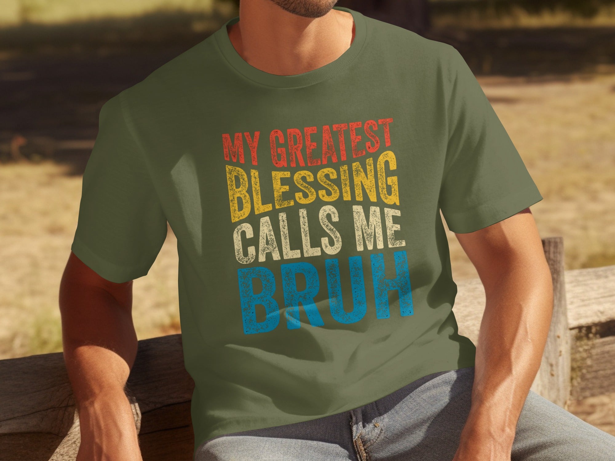 Olive green t-shirt with distressed text reading "MY GREATEST BLESSING CALLS ME BRUH".