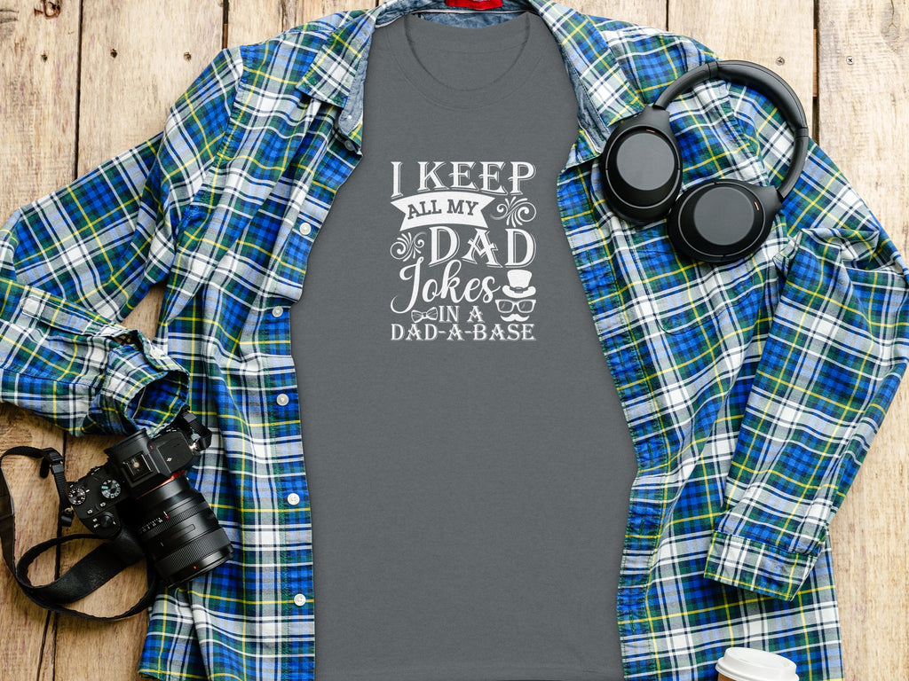 Grey t-shirt with white text "I KEEP ALL MY DAD Jokes IN A DAD-A-BASE".
