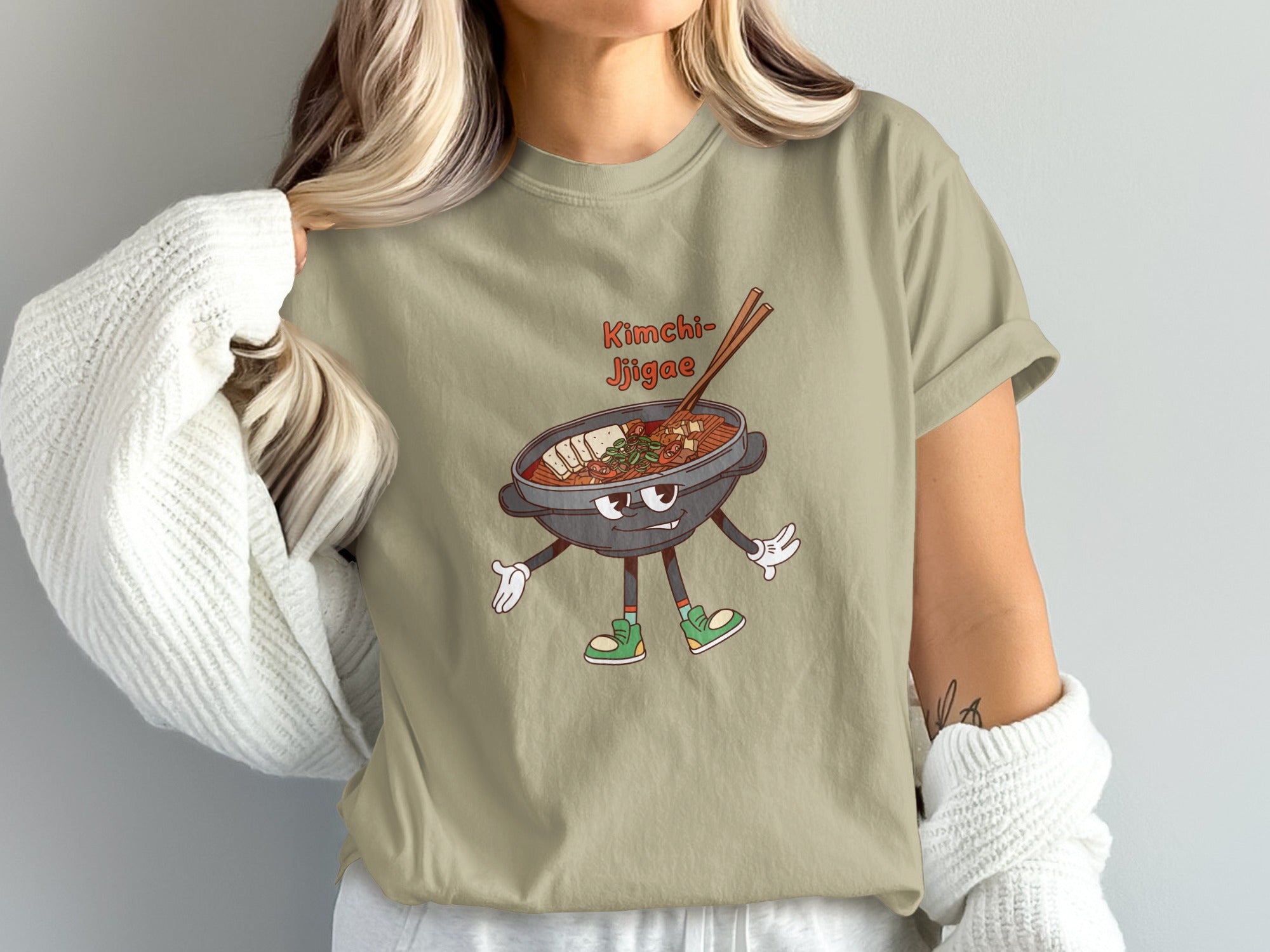 Tee shirt graphic of cartoon kimchi jjigae with chopsticks and text.