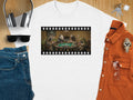 White t-shirt with film strip graphic of animals playing poker.