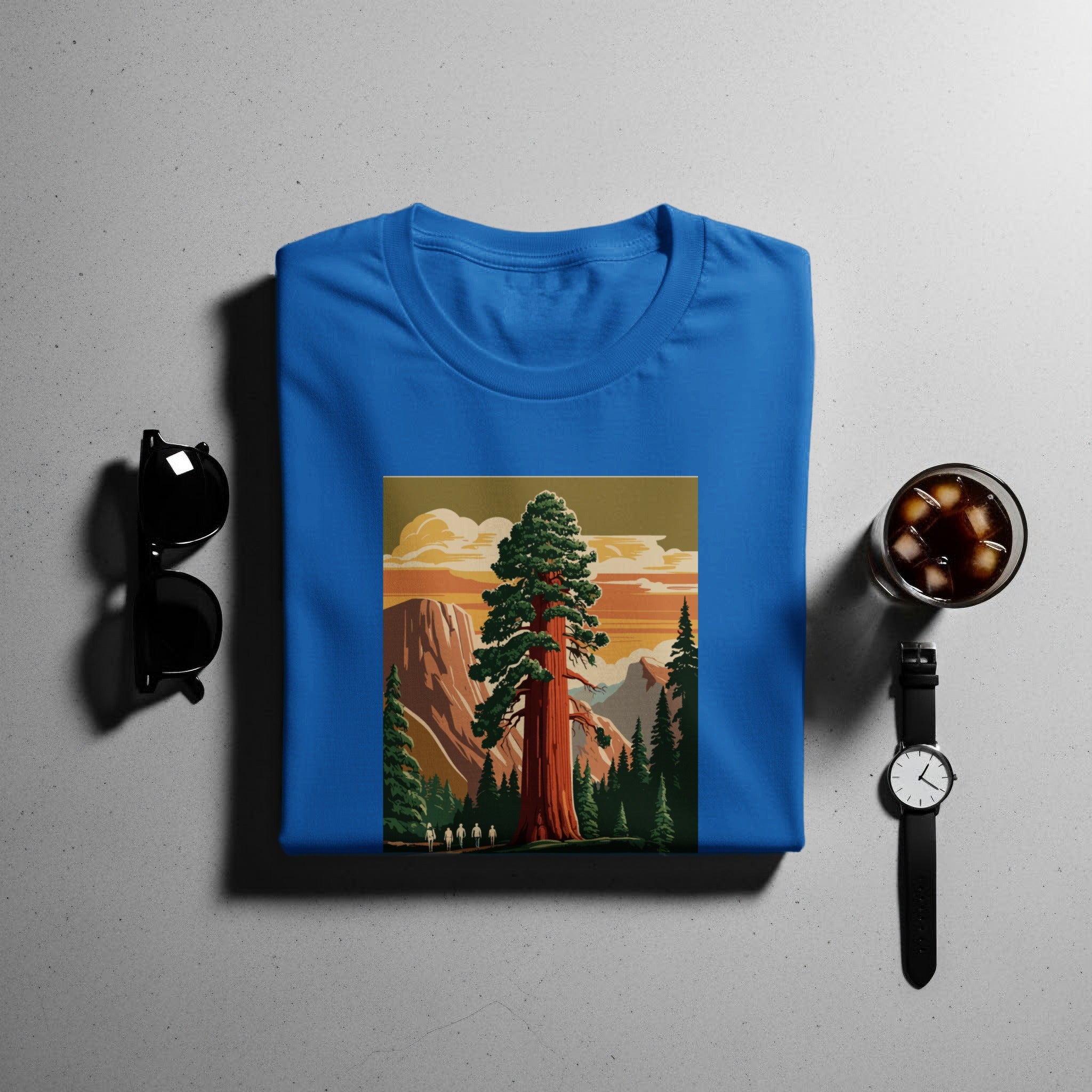 Blue t-shirt with a vintage illustration of a giant redwood tree and hikers.