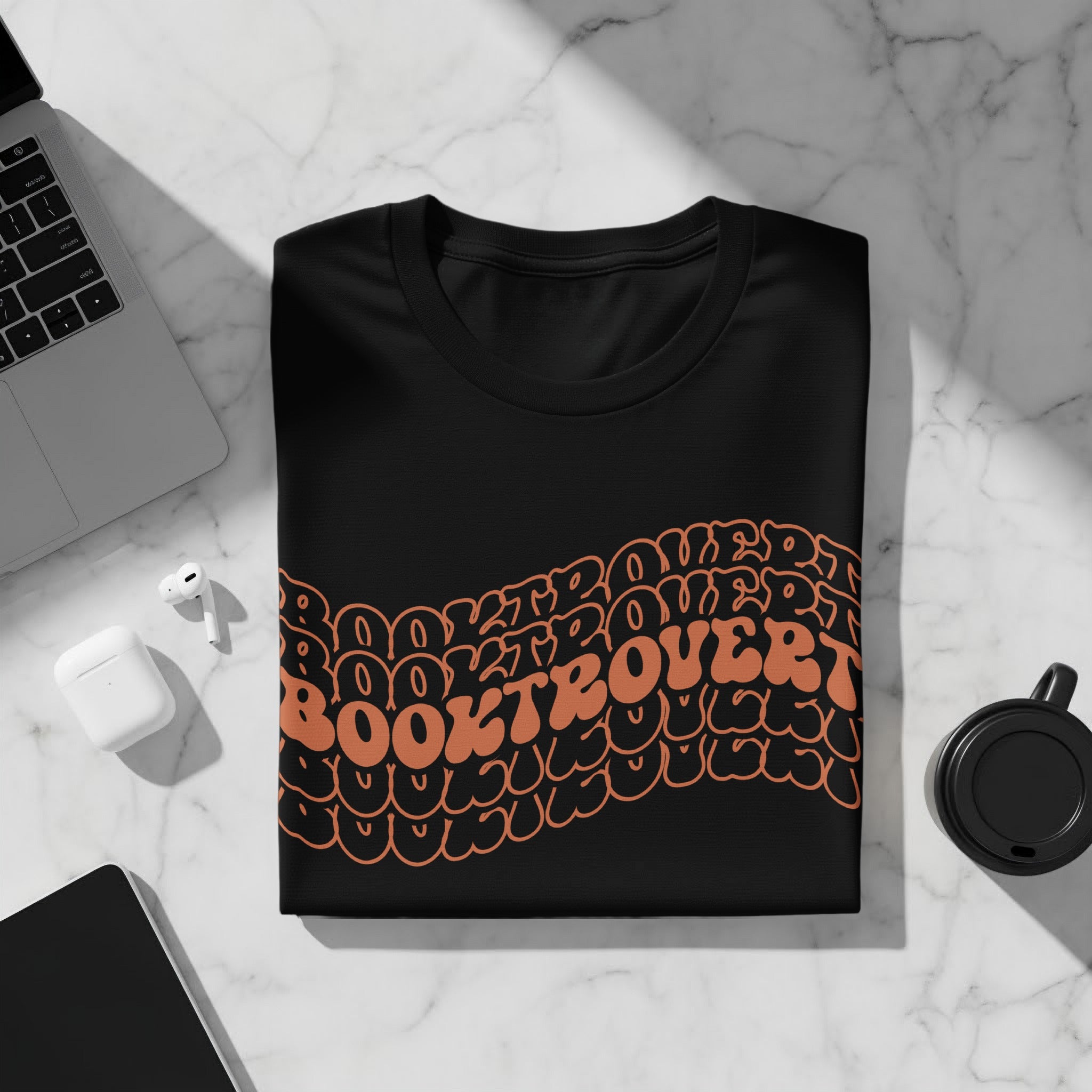 Black t-shirt with orange "BOOKTROVERT" text design.