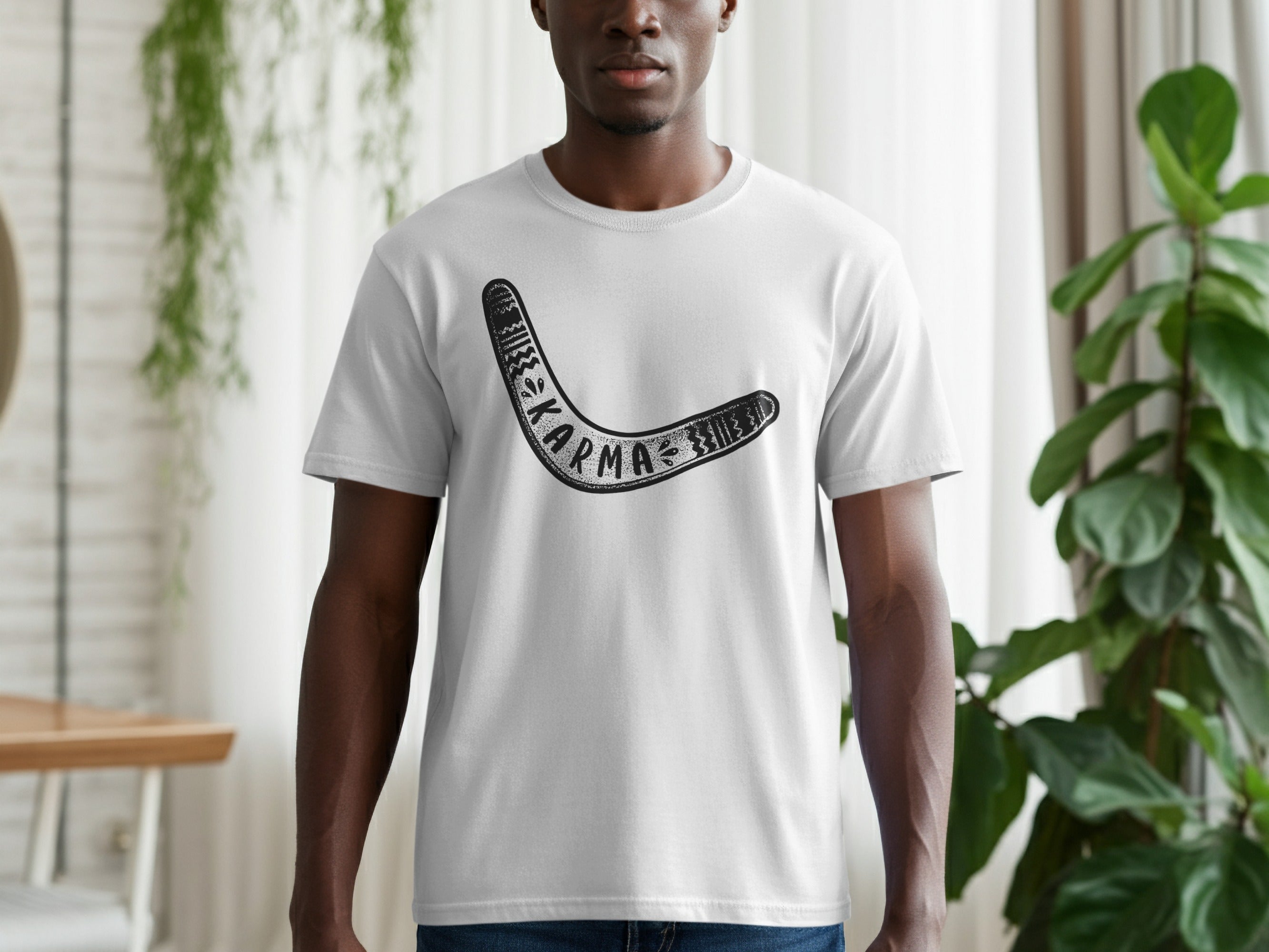 Man wearing a white t-shirt with a black boomerang design and the word "KARMA".